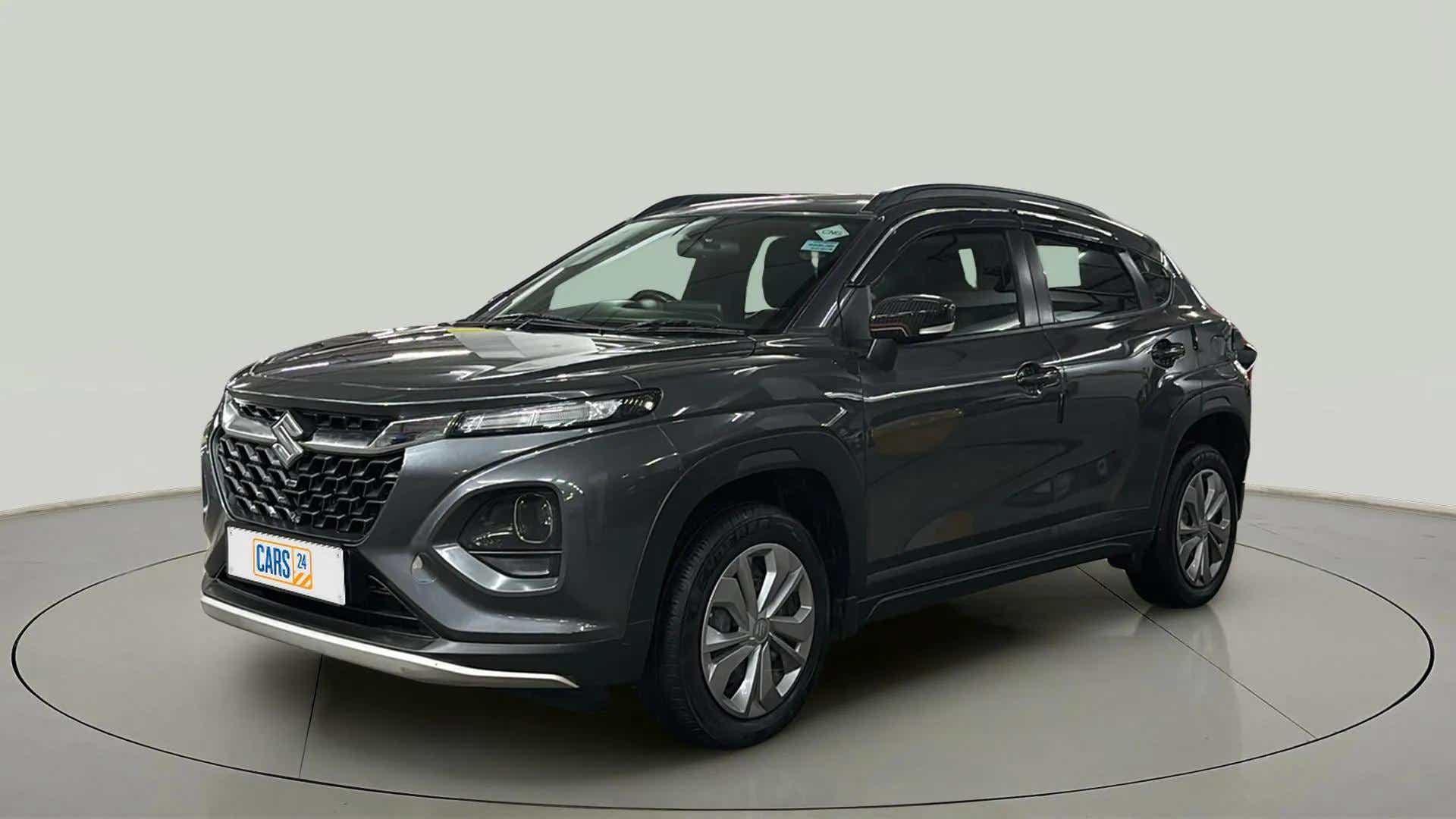 Front three quarter view of a Grandeur Grey Maruti Suzuki FRONX