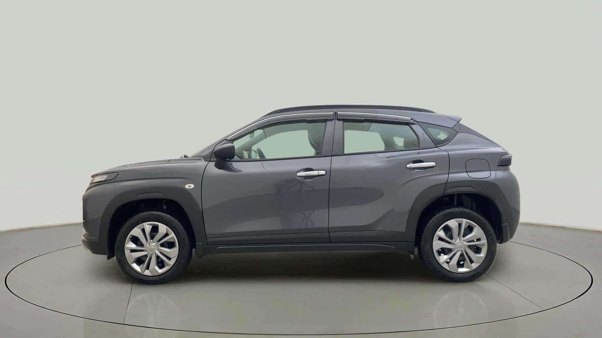 Side view of a Grandeur Grey Maruti Suzuki FRONX