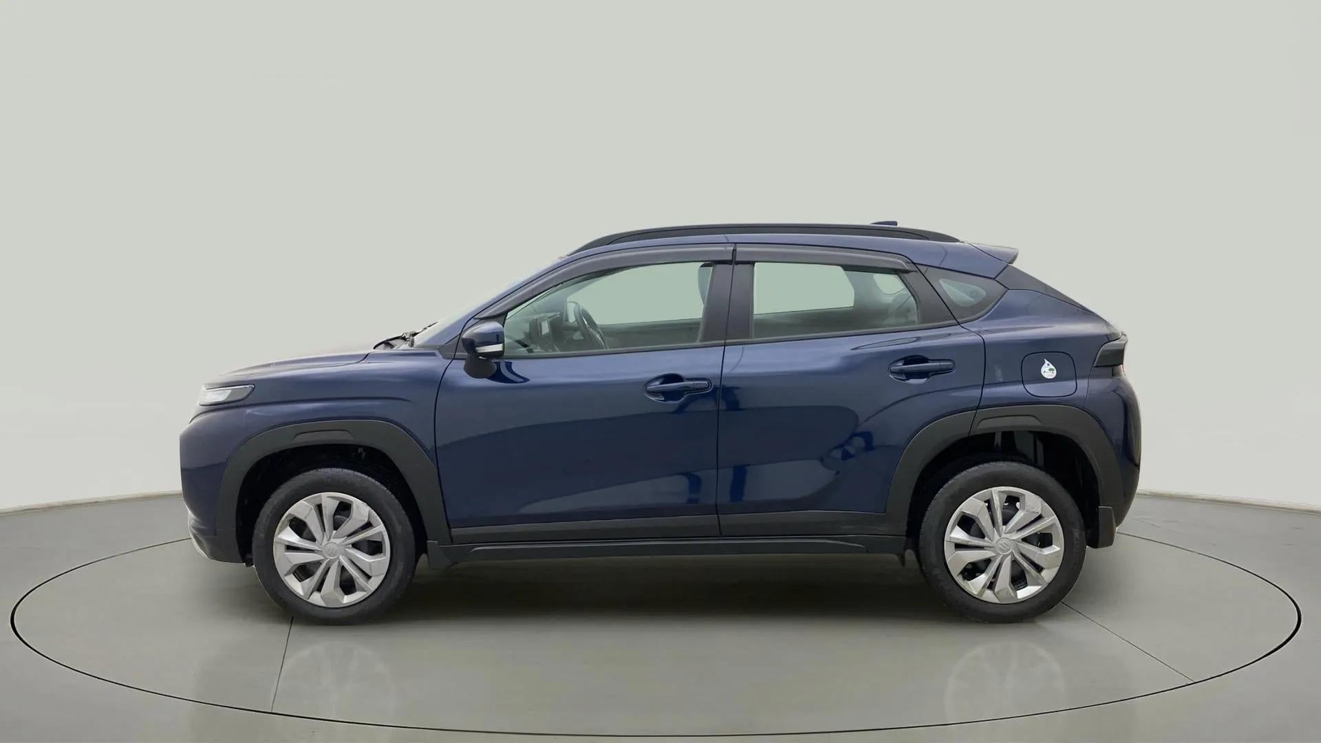 Side view of a Nexa Blue Maruti Suzuki FRONX