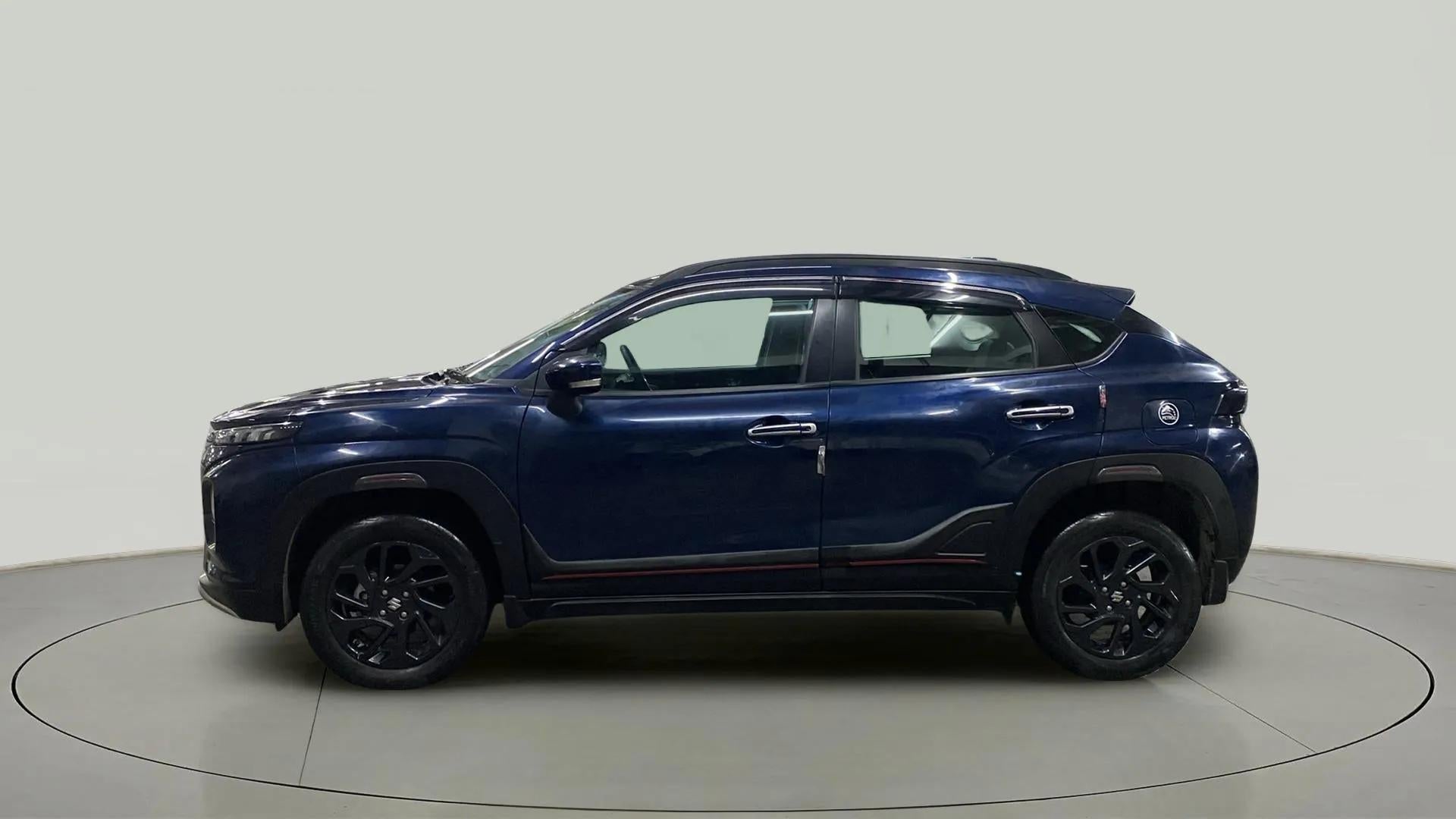 Side view of a Nexa Blue Maruti Suzuki FRONX