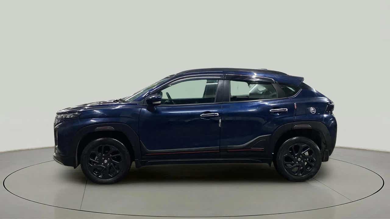 Side view of a Nexa Blue Maruti Suzuki FRONX