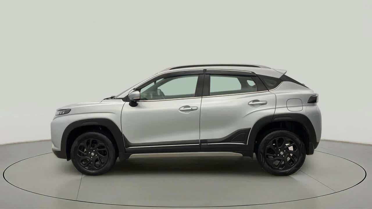 Side profile of a splendid silver with black Maruti Suzuki FRONX