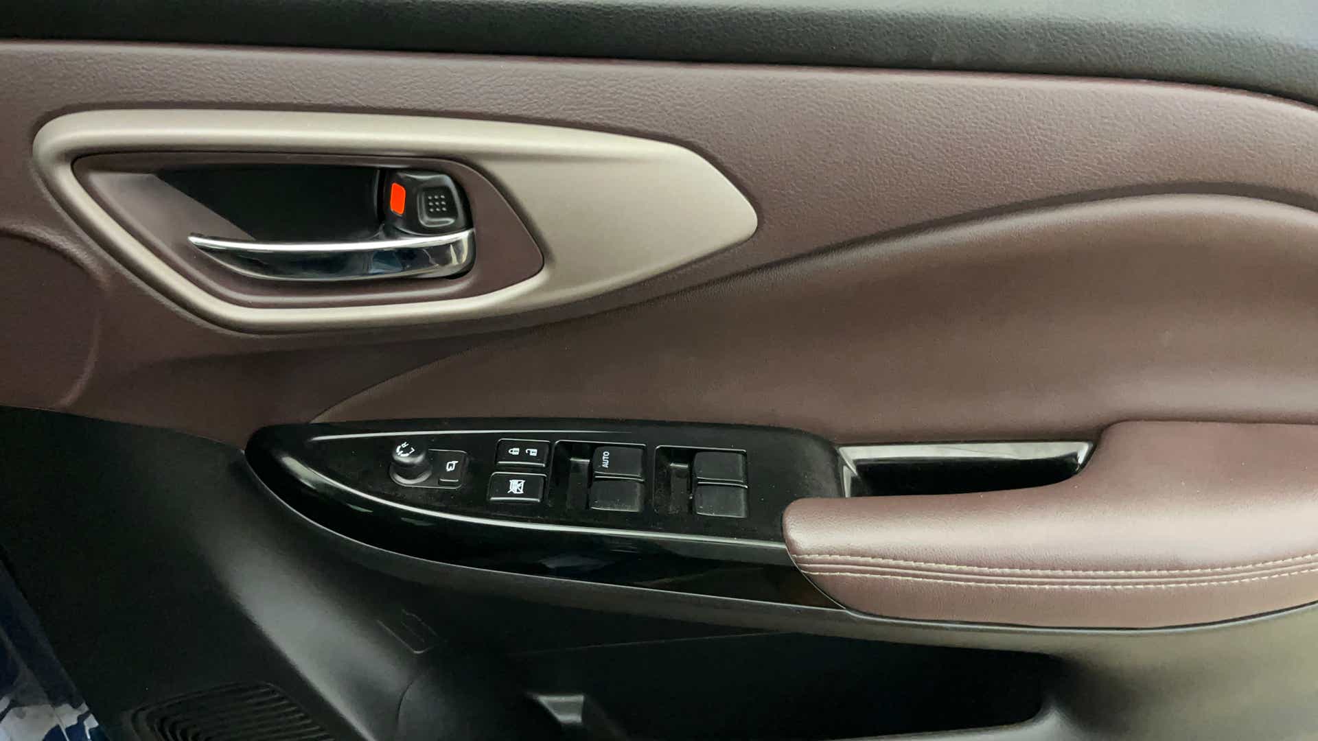 Driver-side door controls of a Maruti Suzuki FRONX