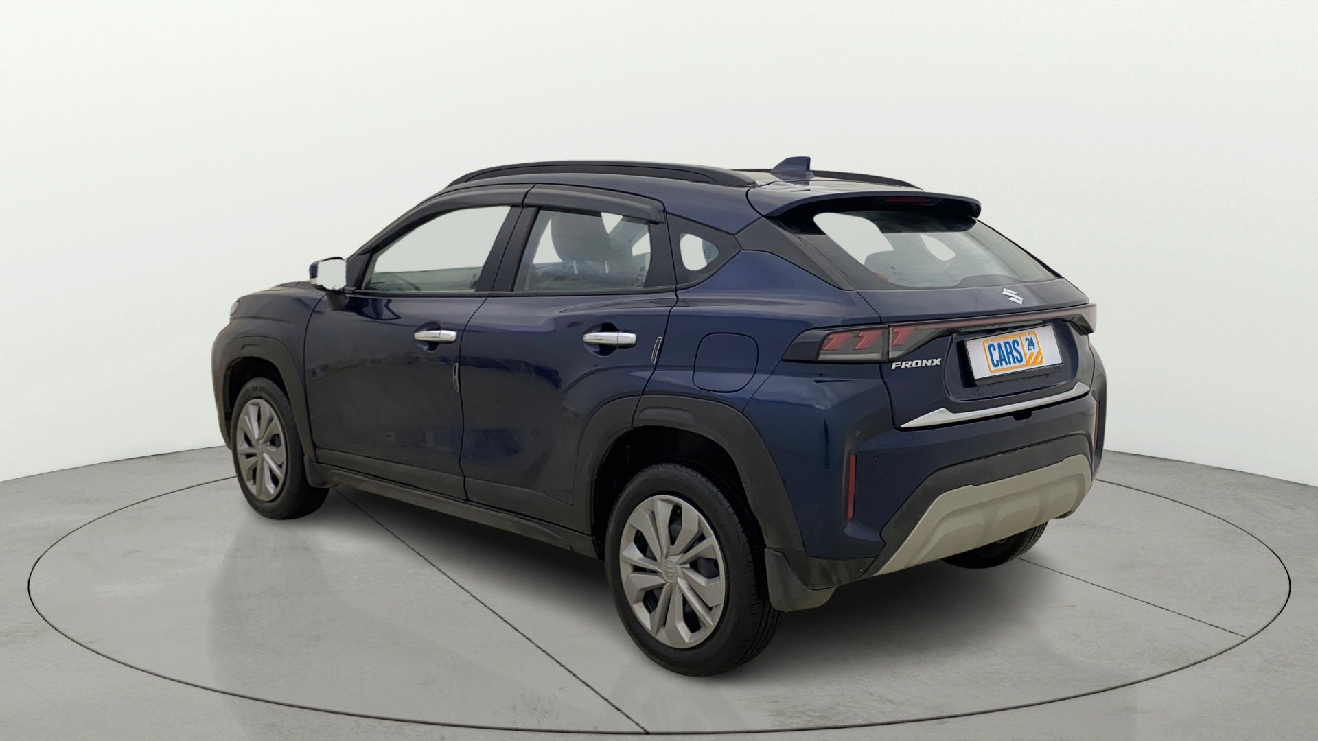 Rear three-quarter view of a Nexa Blue Maruti Suzuki FRONX