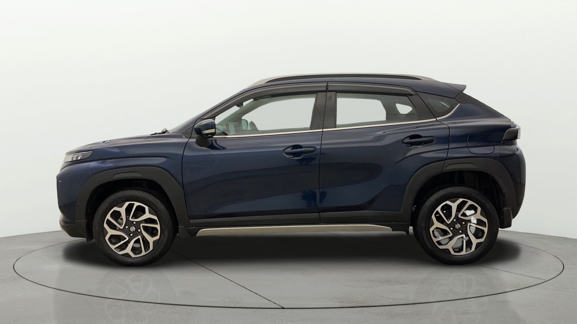 Side view of a Nexa Blue Maruti Suzuki FRONX