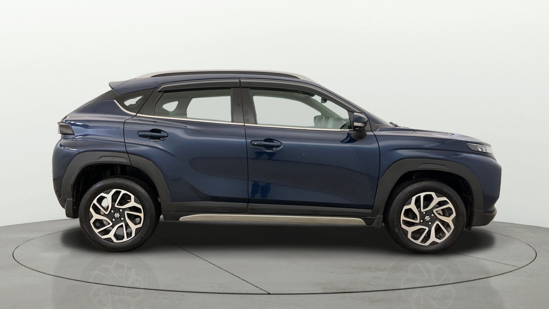 Side profile of a Nexa Blue Maruti Suzuki FRONX