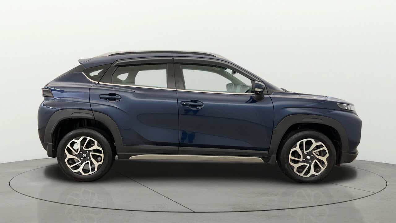 Side profile of a Nexa Blue Maruti Suzuki FRONX