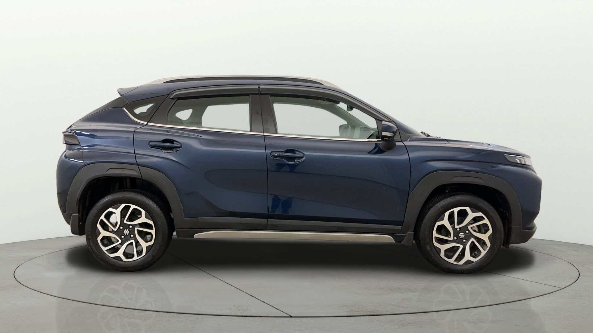 Side profile of a Nexa Blue Maruti Suzuki FRONX