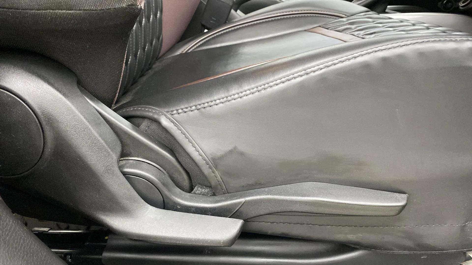 Close-up of the seat height adjuster lever of a Maruti Suzuki FRONX