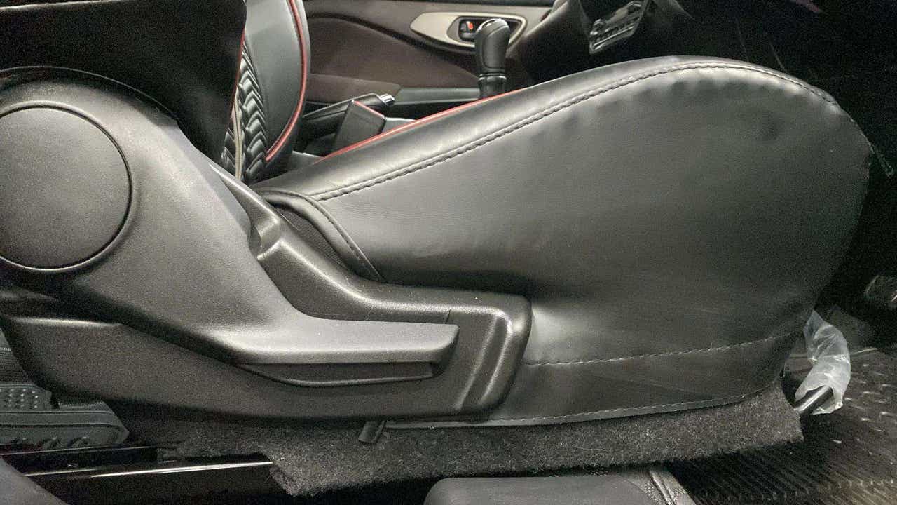 Side view of the front seat adjustment lever of a Maruti Suzuki FRONX