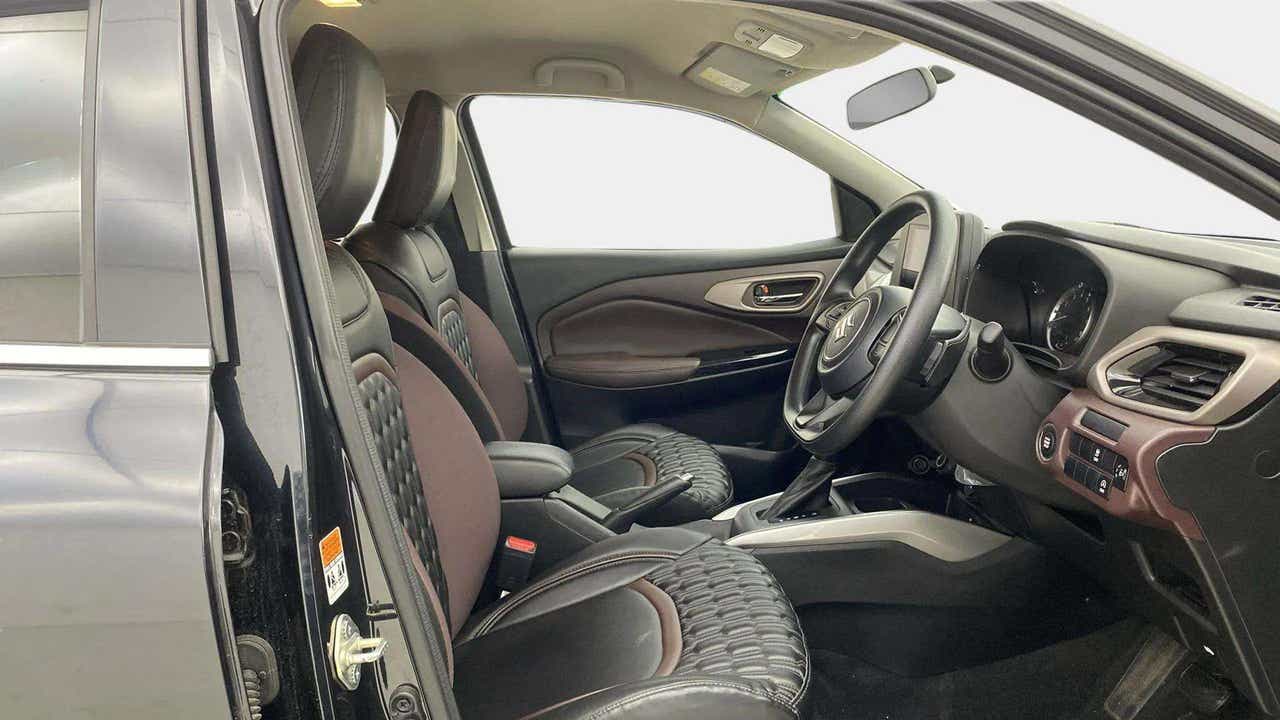 Interior front seat and dashboard view of a Maruti Suzuki FRONX