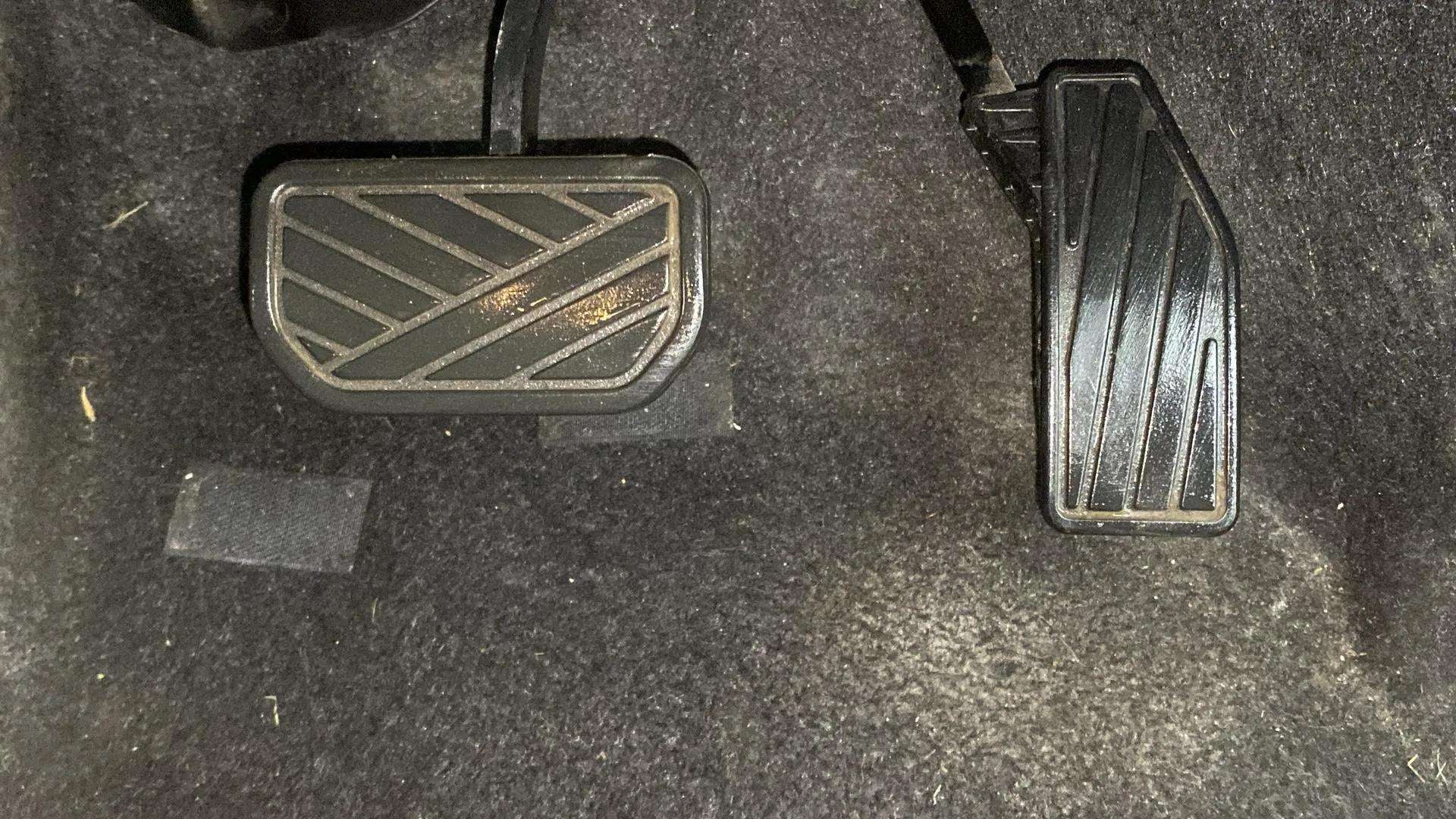 Footwell showing brake and accelerator pedals of a Maruti Suzuki FRONX