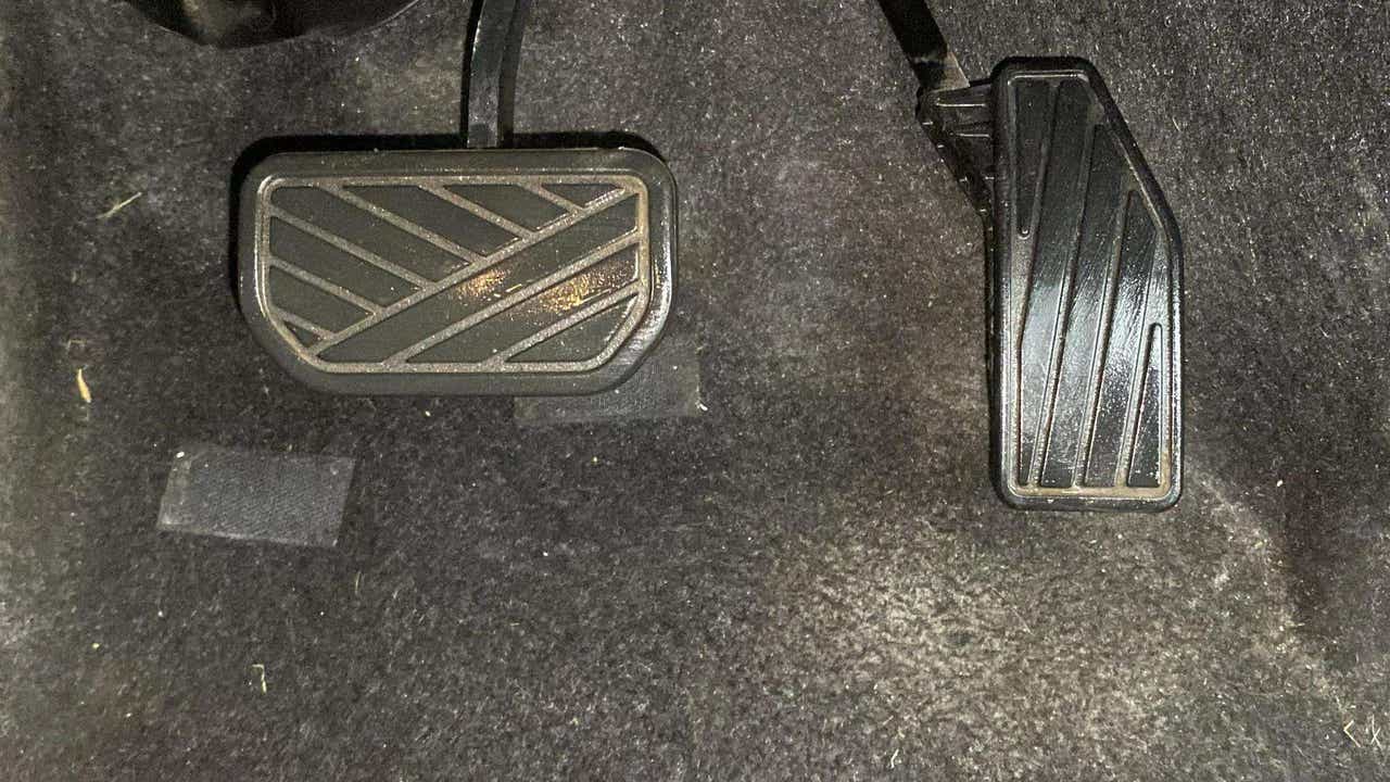 Footwell showing brake and accelerator pedals of a Maruti Suzuki FRONX