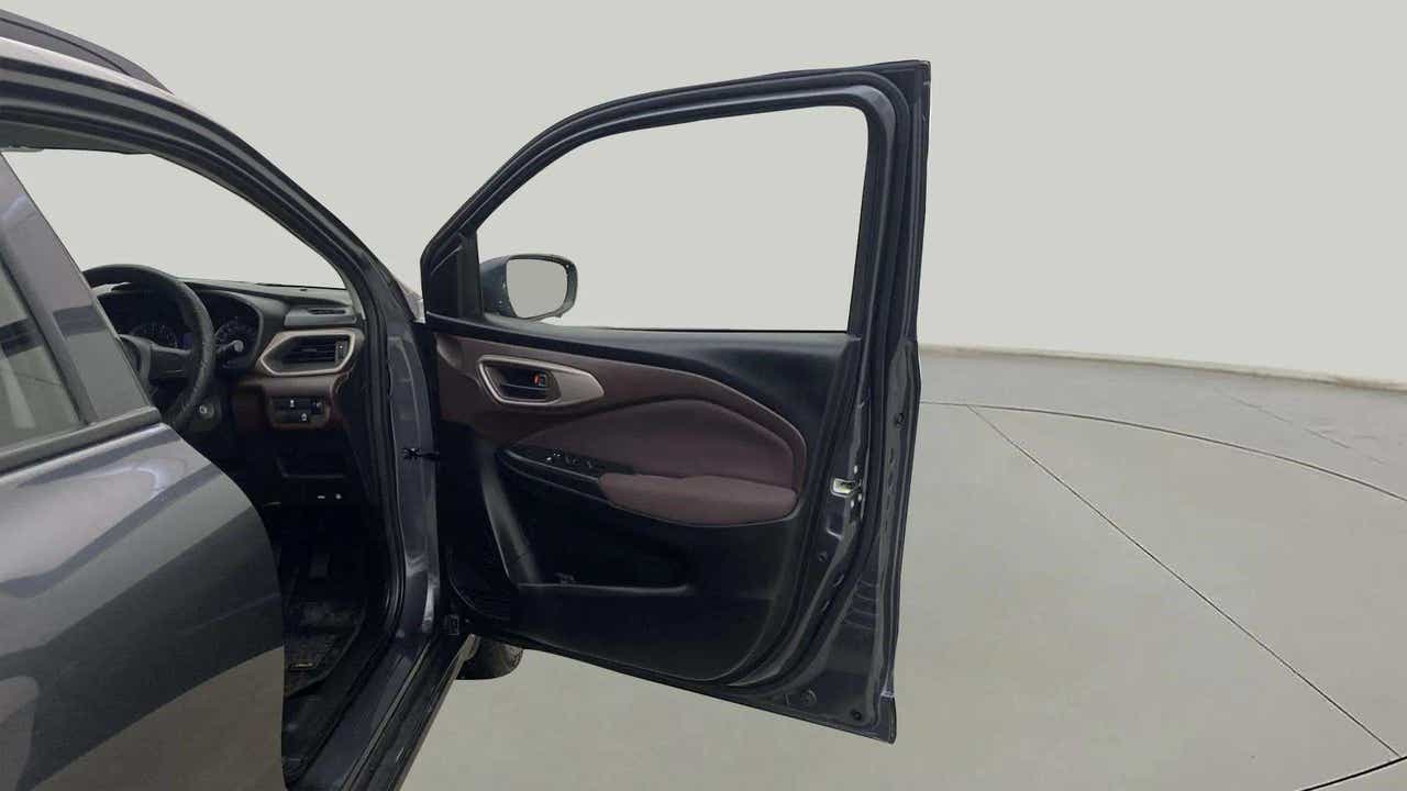 Front driver side door and dashboard view of a Maruti Suzuki FRONX