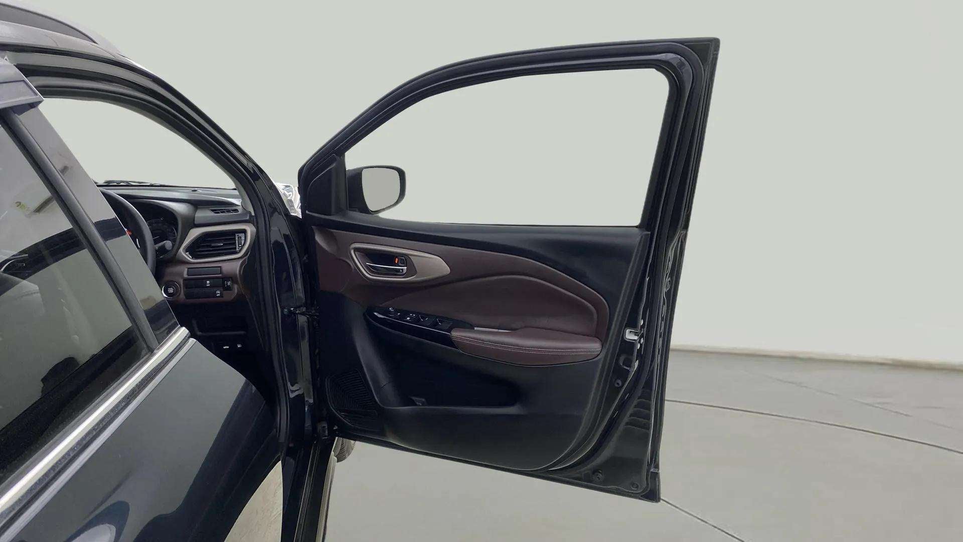 Front driver-side door and dashboard of a Maruti Suzuki FRONX
