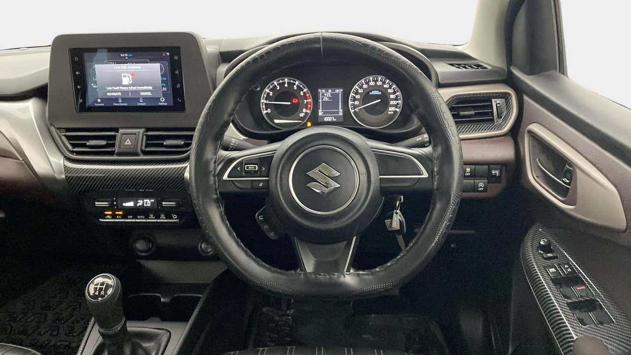 Interior dashboard and steering wheel view of a Maruti Suzuki FRONX