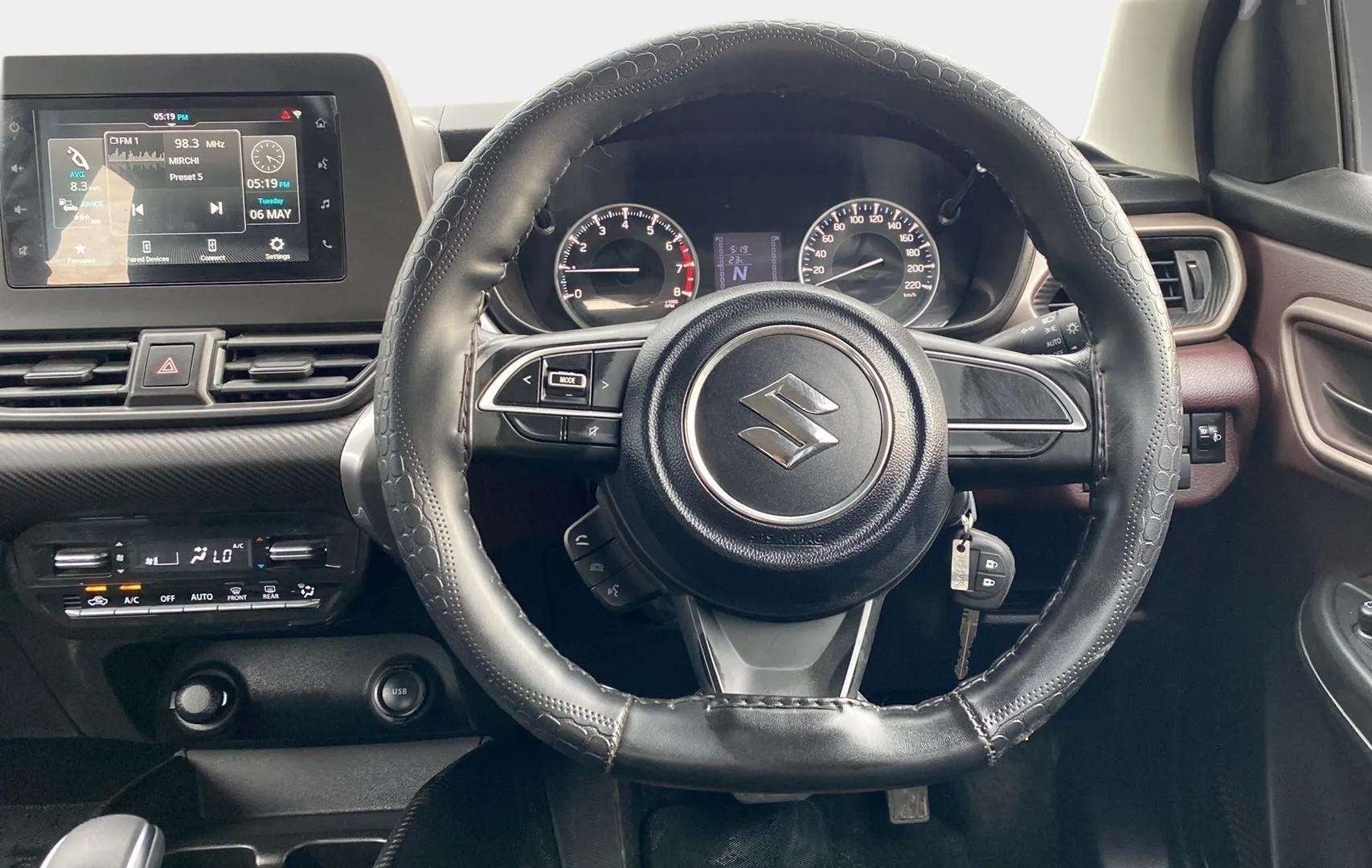 Interior dashboard and steering wheel of a Maruti Suzuki FRONX