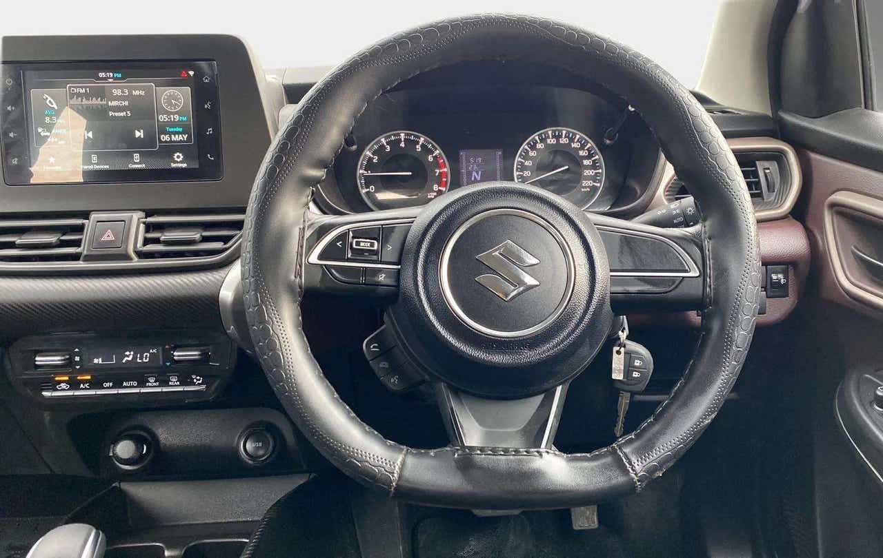 Interior dashboard and steering wheel of a Maruti Suzuki FRONX
