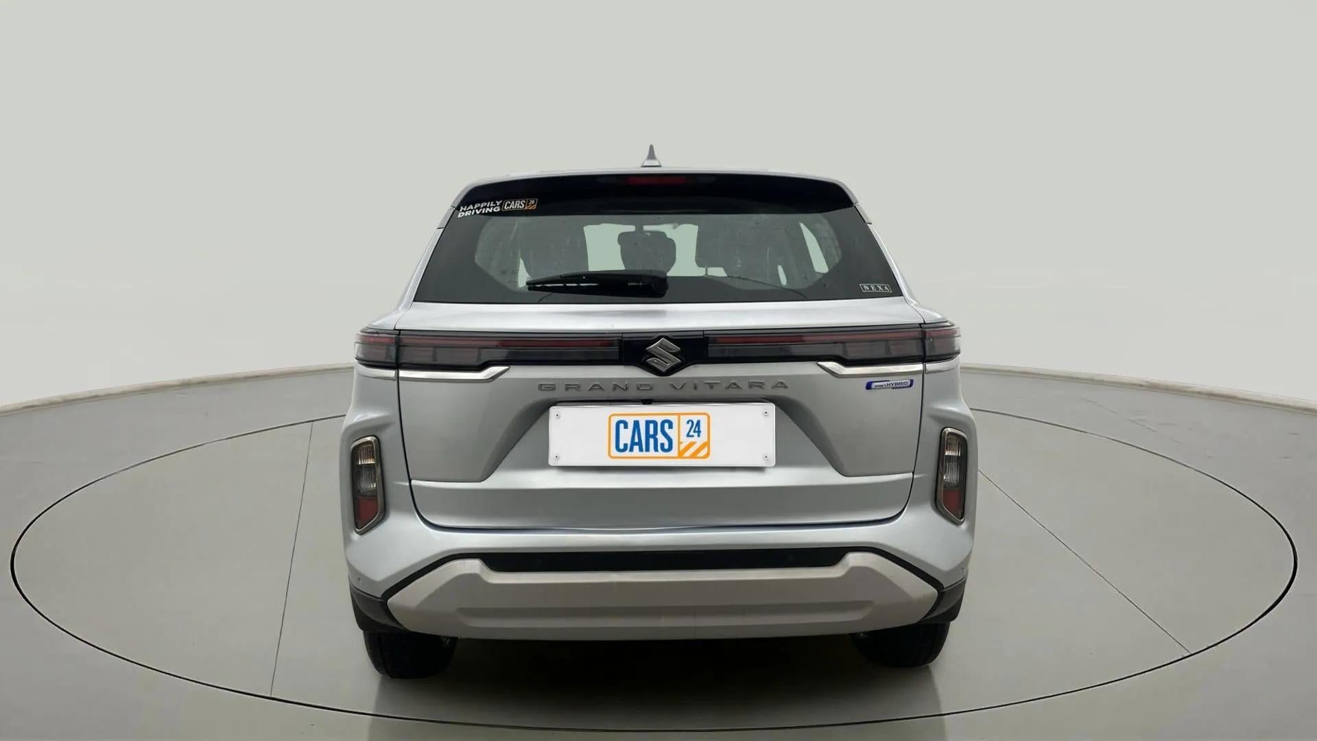 Rear view of a Splendid Silver Maruti Suzuki Grand Vitara