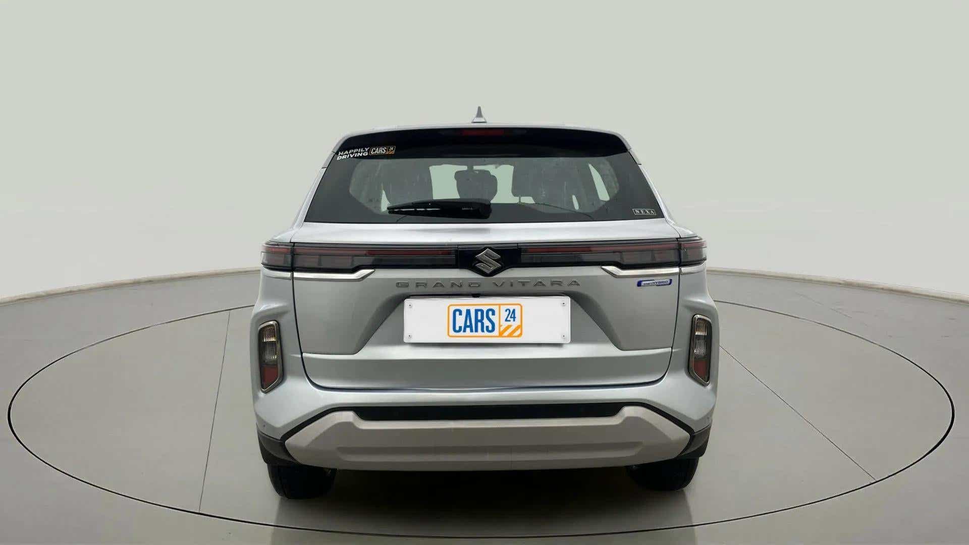 Rear view of a Splendid Silver Maruti Suzuki Grand Vitara