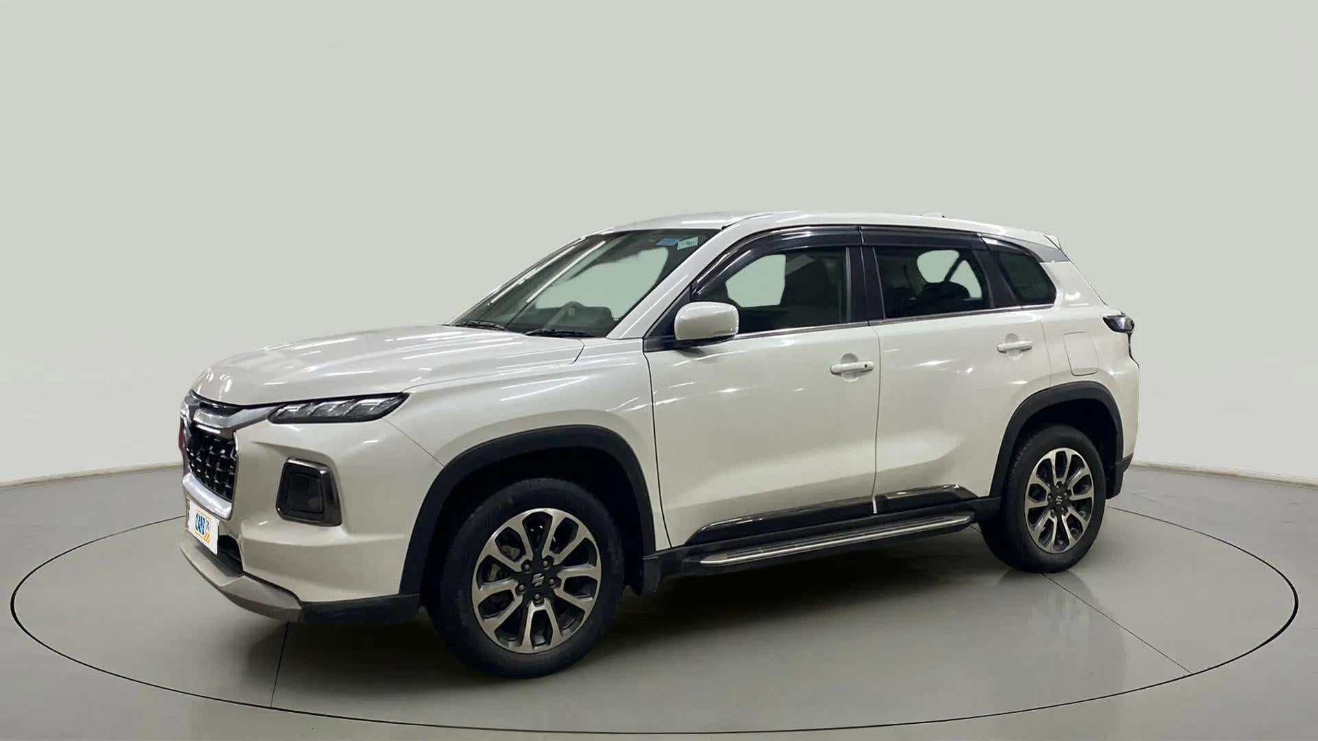 Front and side view of a Splendid Silver Maruti Suzuki Grand Vitara