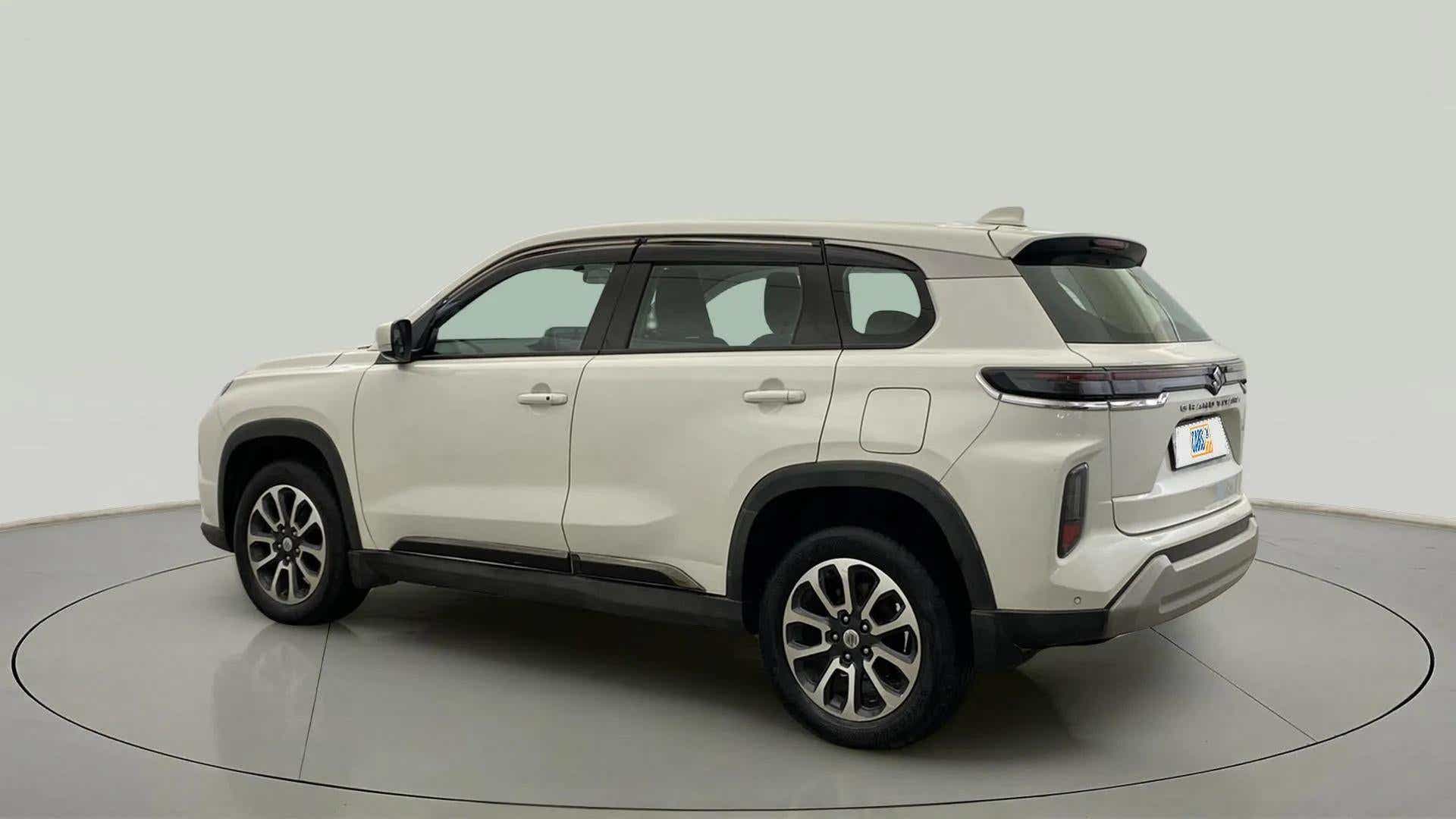 Rear three-quarter of a splendid silver Maruti Suzuki Grand Vitara