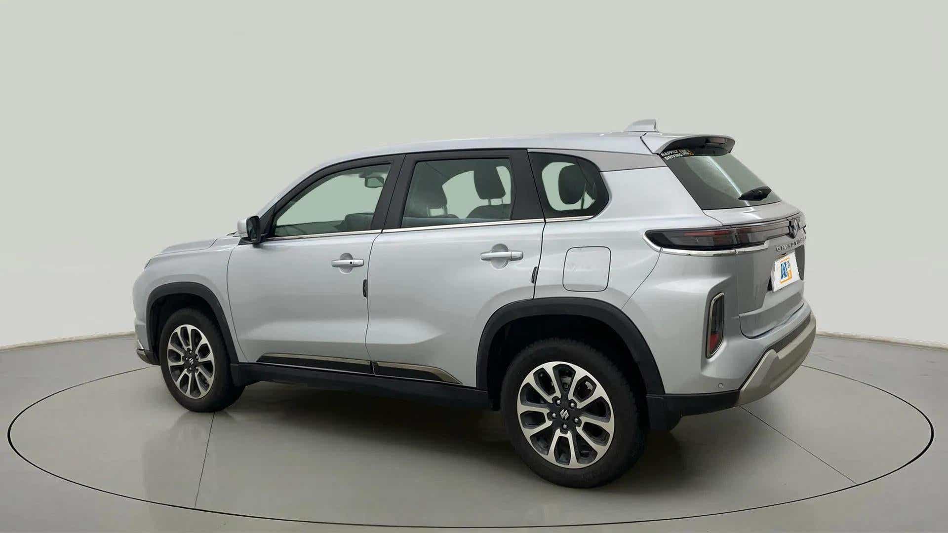 Rear three quarter of a Splendid Silver Maruti Suzuki Grand Vitara