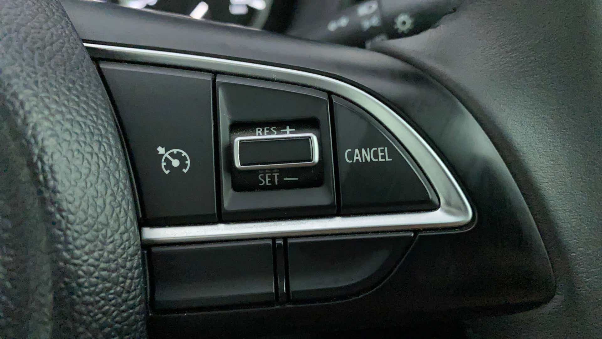Cruise control buttons on a Maruti Suzuki Grand Vitara steering wheel