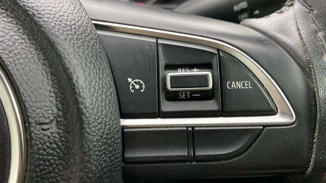 Steering wheel cruise control buttons of a Maruti Suzuki Grand Vitara
