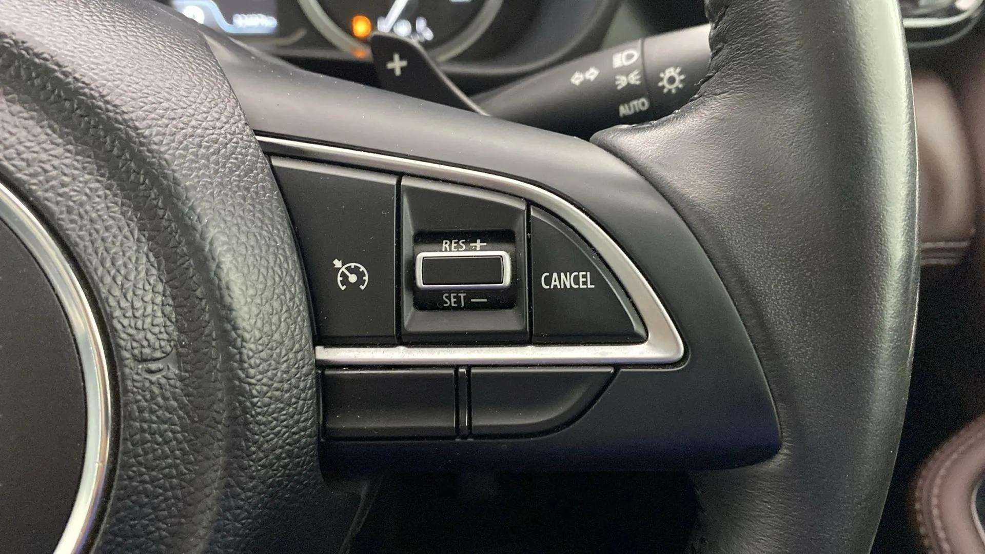 Steering wheel cruise control buttons of a Maruti Suzuki Grand Vitara