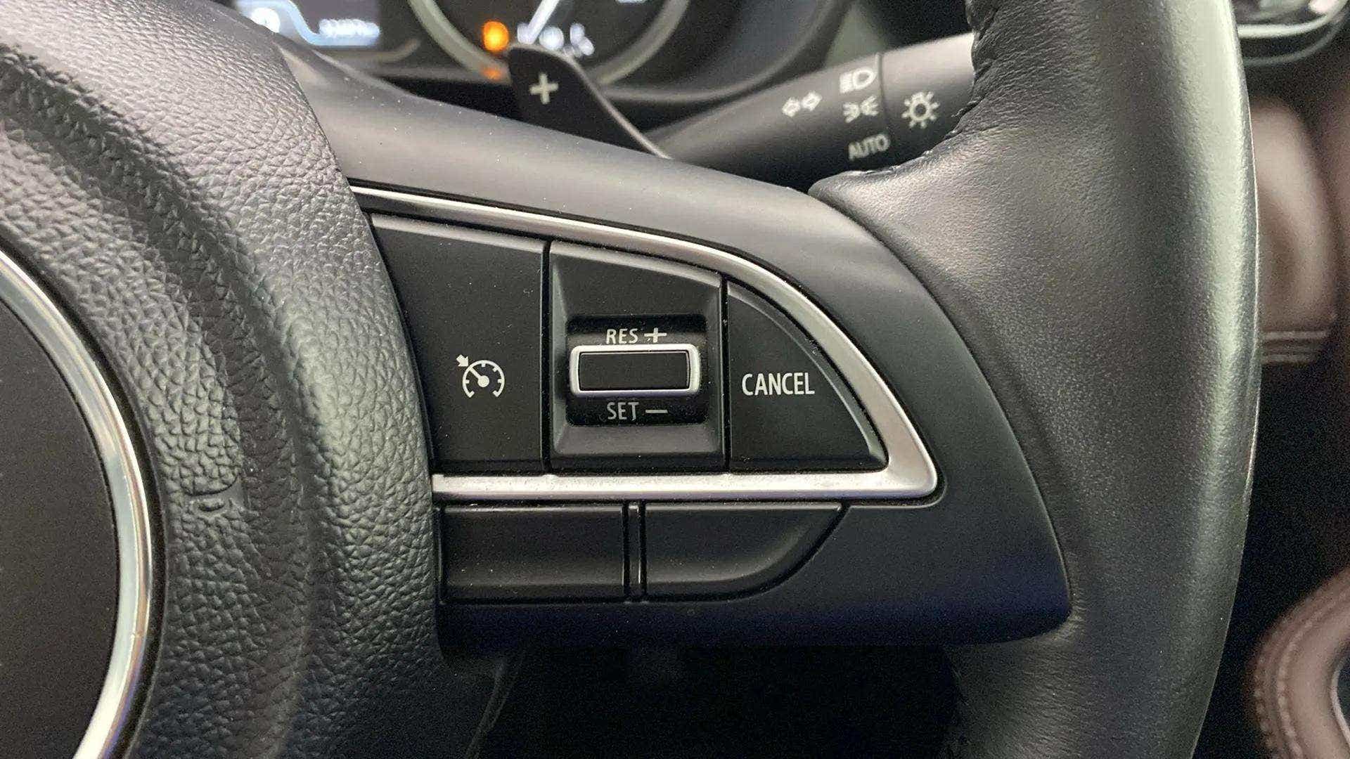Steering wheel cruise control buttons of a Maruti Suzuki Grand Vitara