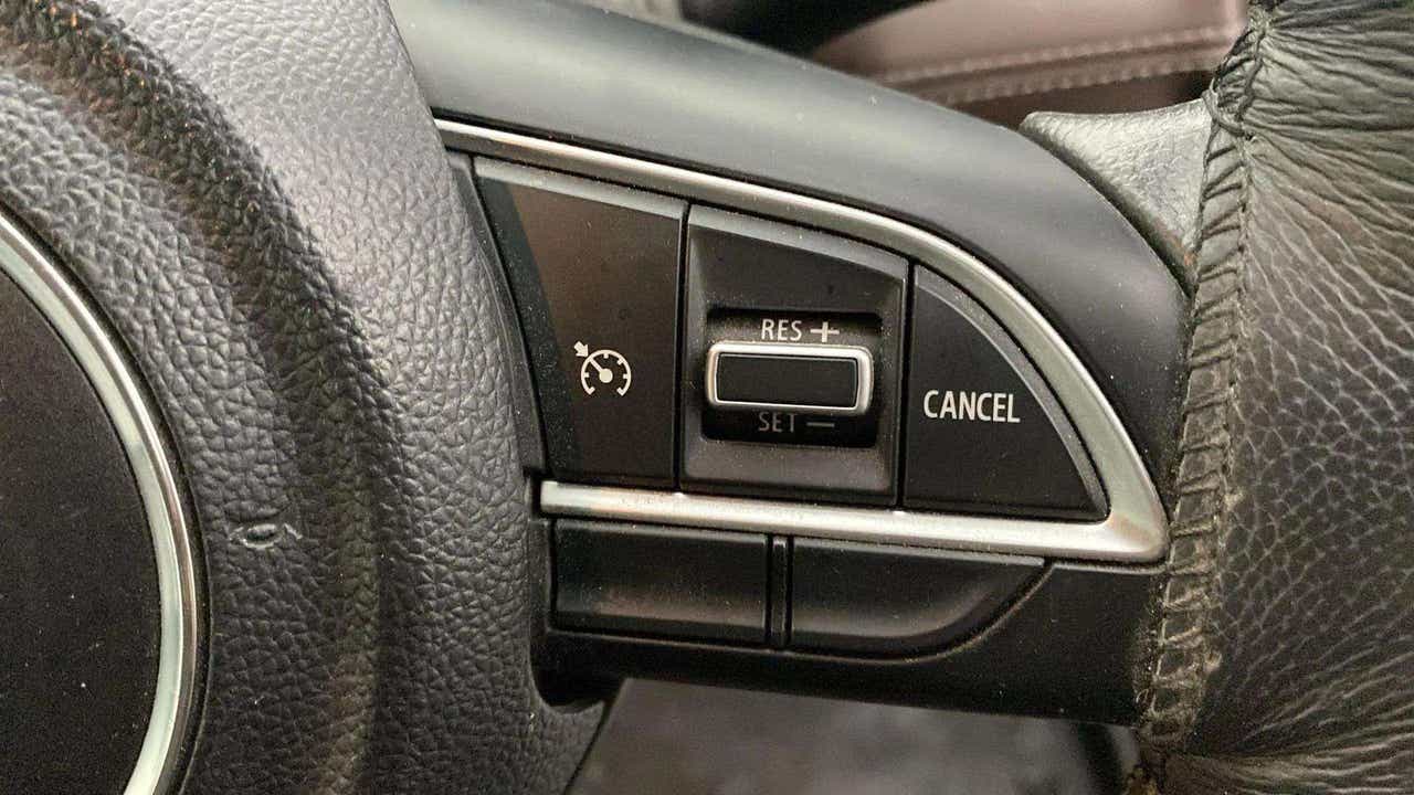 Steering wheel cruise control buttons of a Maruti Suzuki Grand Vitara