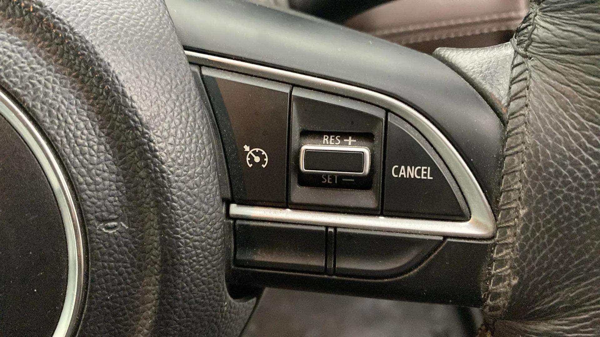 Steering wheel cruise control buttons of a Maruti Suzuki Grand Vitara