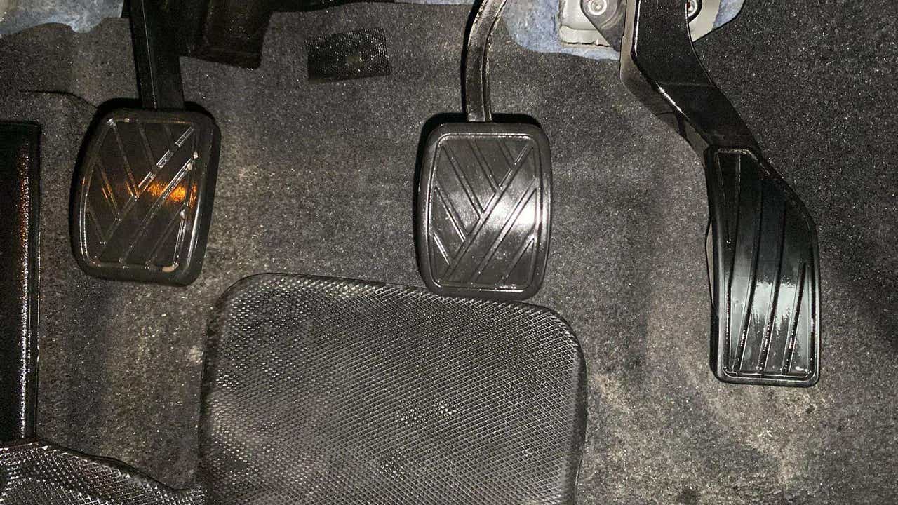 Footwell area showing clutch, brake, and accelerator pedals of a Maruti Suzuki Grand Vitara