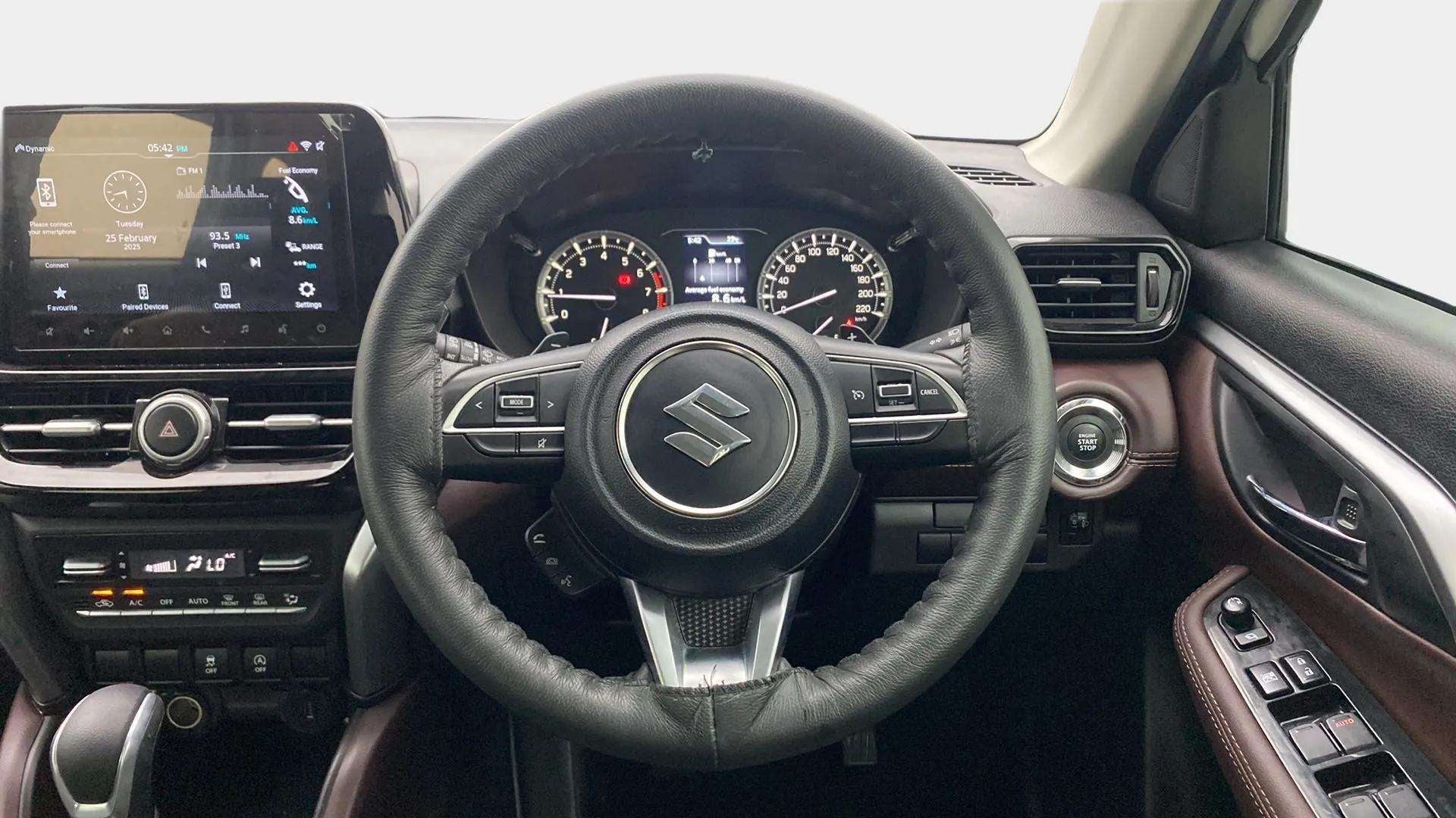 Interior dashboard and steering wheel of a Maruti Suzuki Grand Vitara