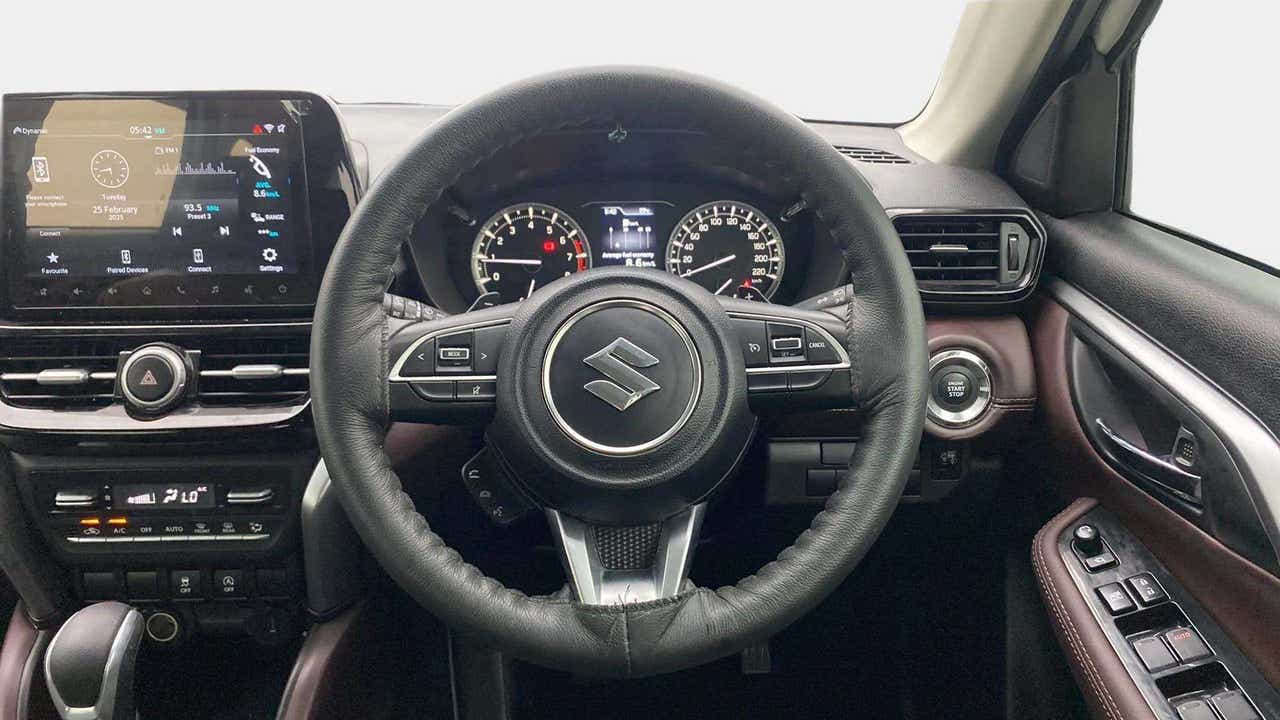 Interior dashboard and steering wheel of a Maruti Suzuki Grand Vitara