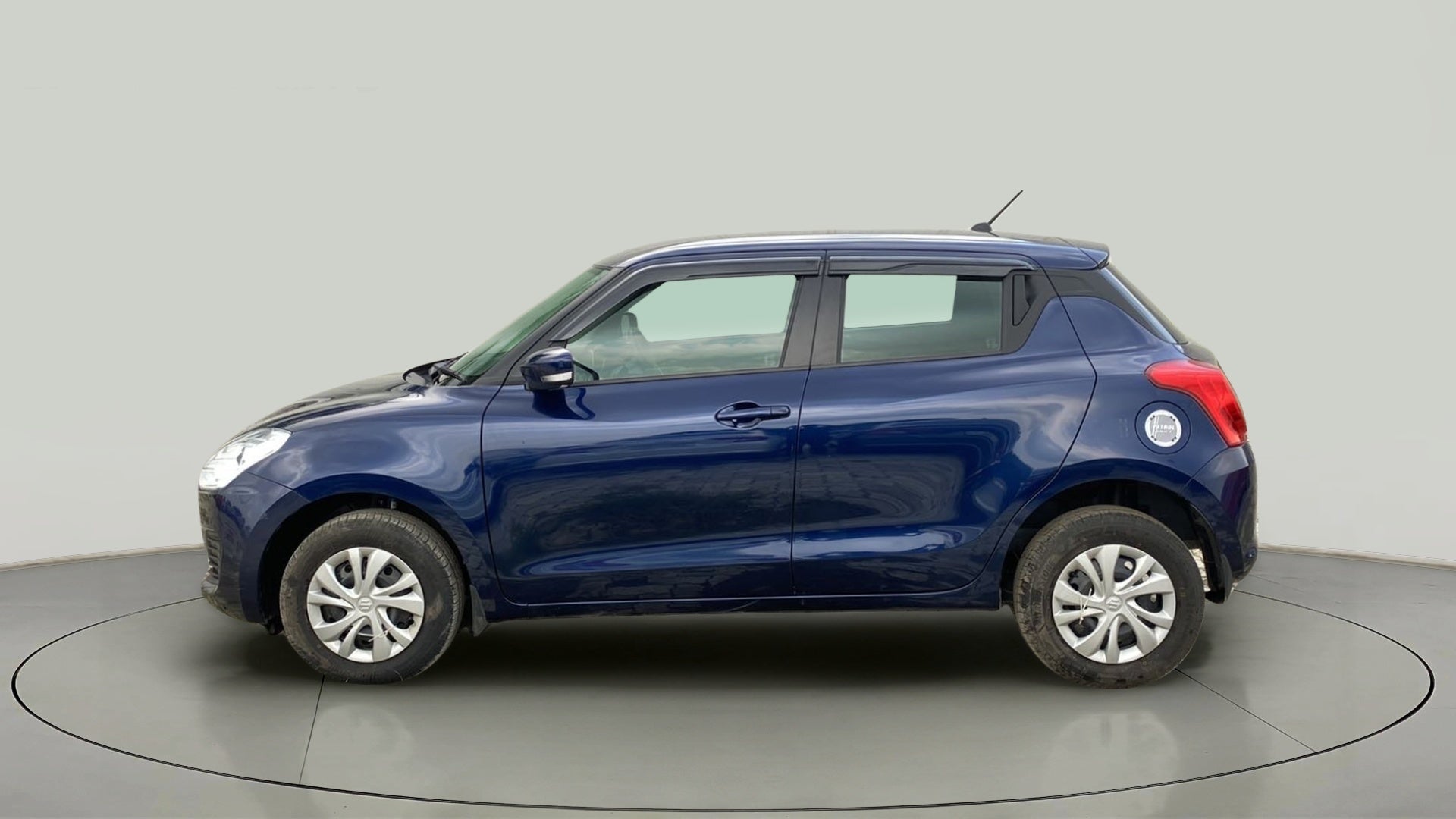 Side view of a Pearl Metallic Midnight Blue Maruti Suzuki Swift 2021 - 2023