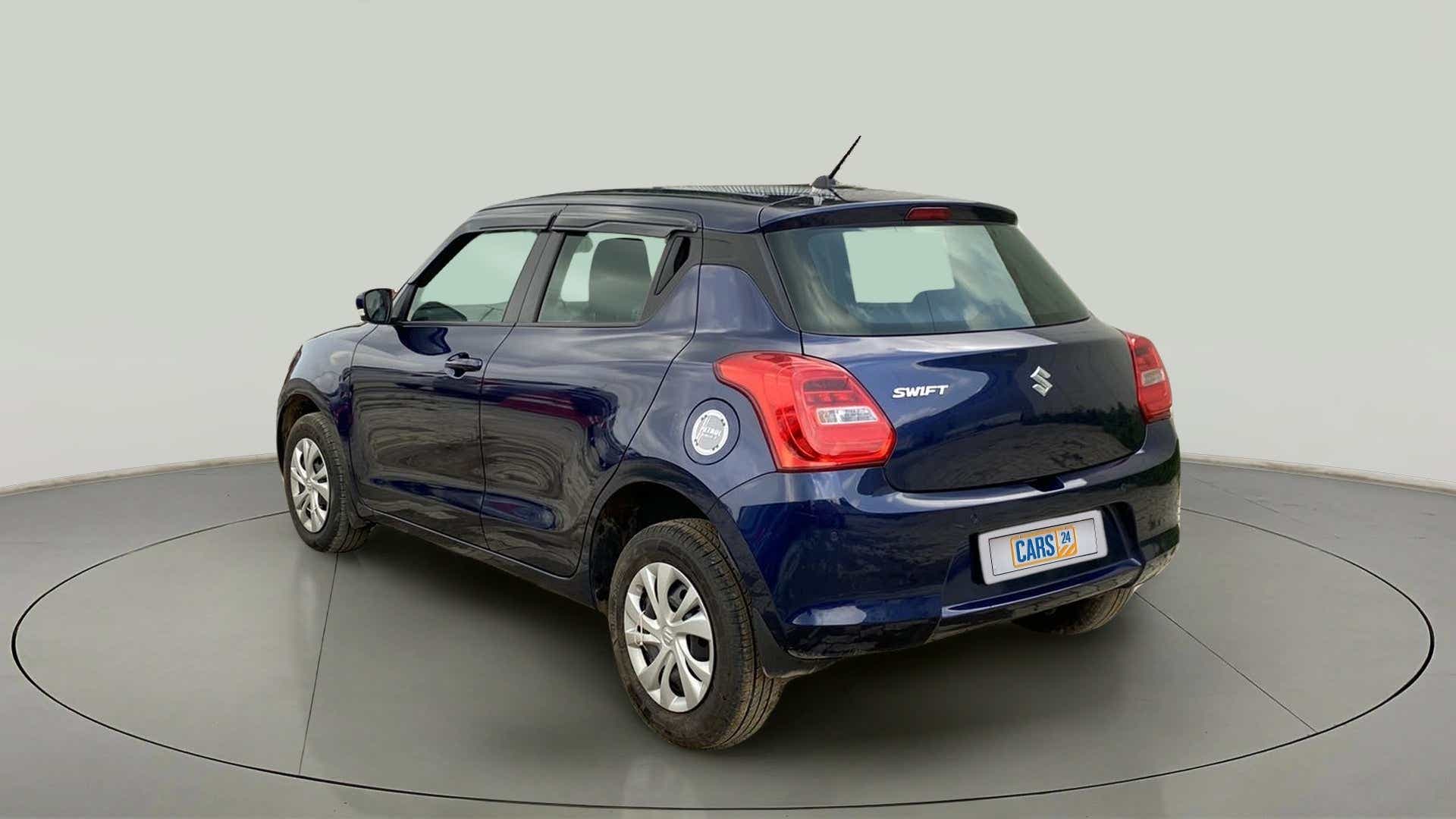 Rear three-quarter view of a pearl-metallic-midnight-blue Maruti Suzuki Swift 2021 - 2023