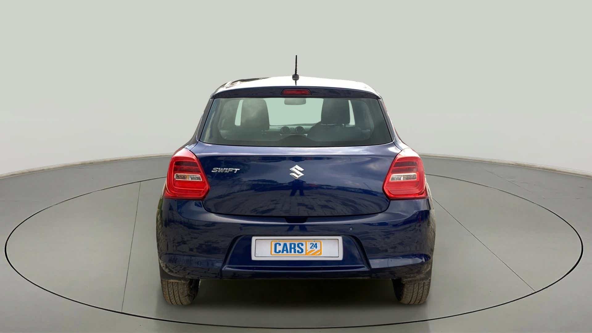 Rear view of a pearl-metallic-midnight-blue Maruti Suzuki Swift 2021 - 2023