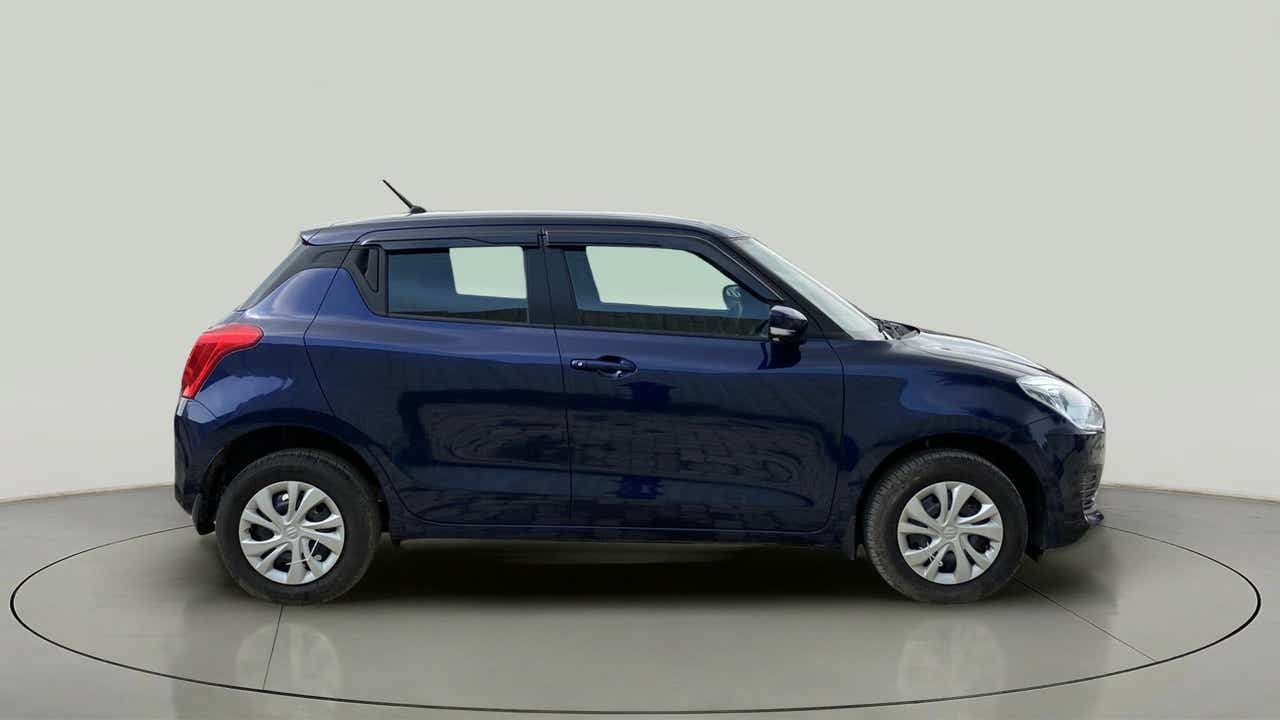 Side view of a pearl metallic midnight blue Maruti Suzuki Swift 2021 - 2023
