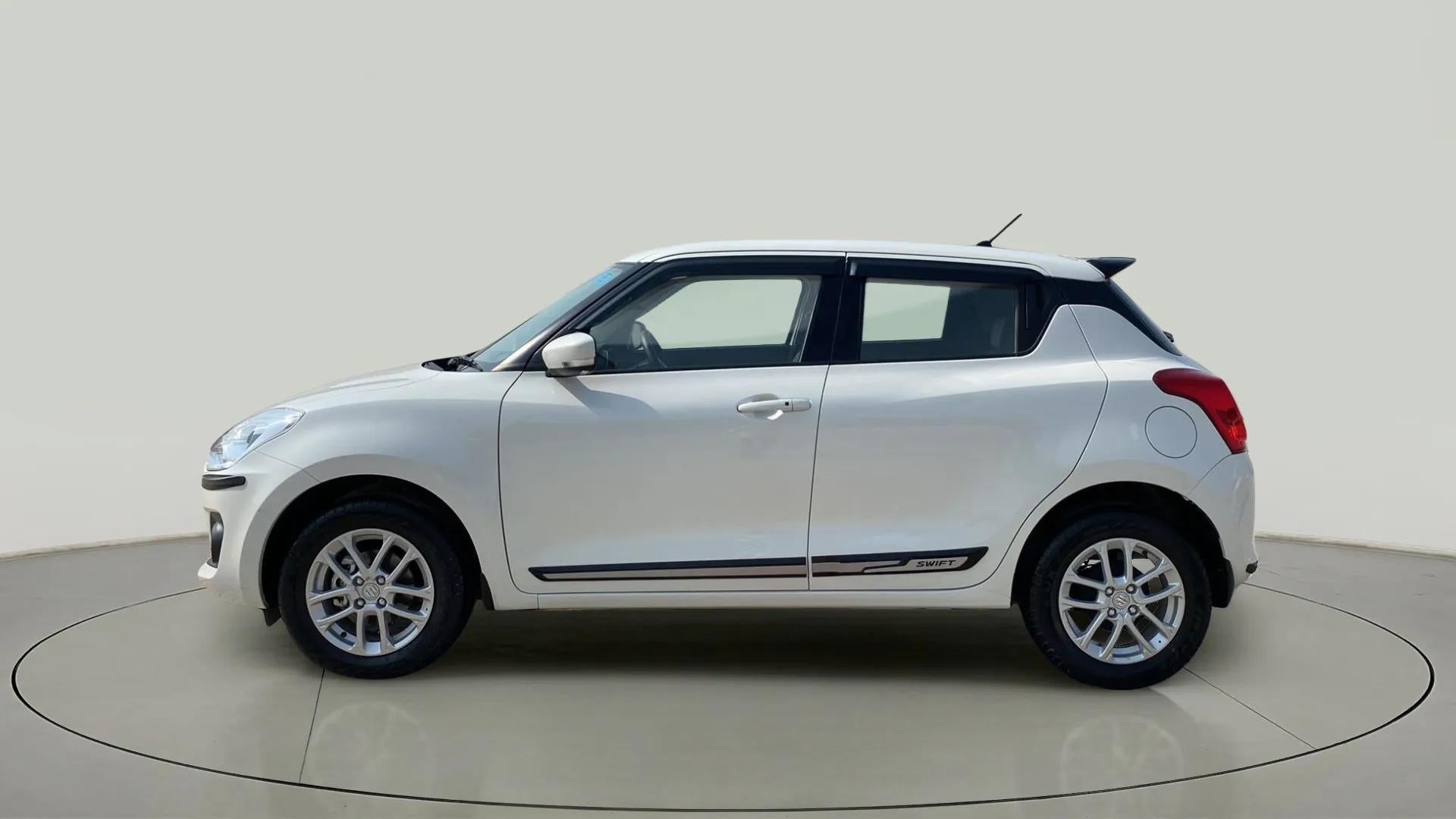 Side view of a Pearl Arctic White with Pearl Midnight Black Maruti Suzuki Swift