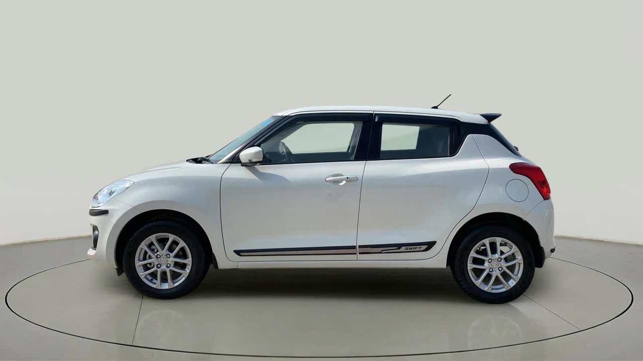 Side view of a Pearl Arctic White with Pearl Midnight Black Maruti Suzuki Swift