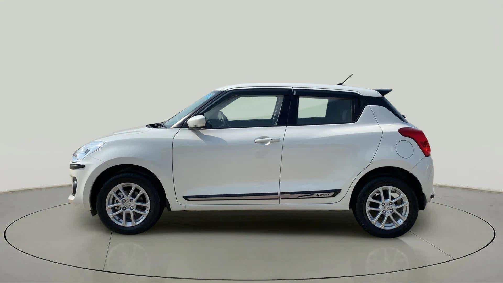 Side view of a Pearl Arctic White with Pearl Midnight Black Maruti Suzuki Swift