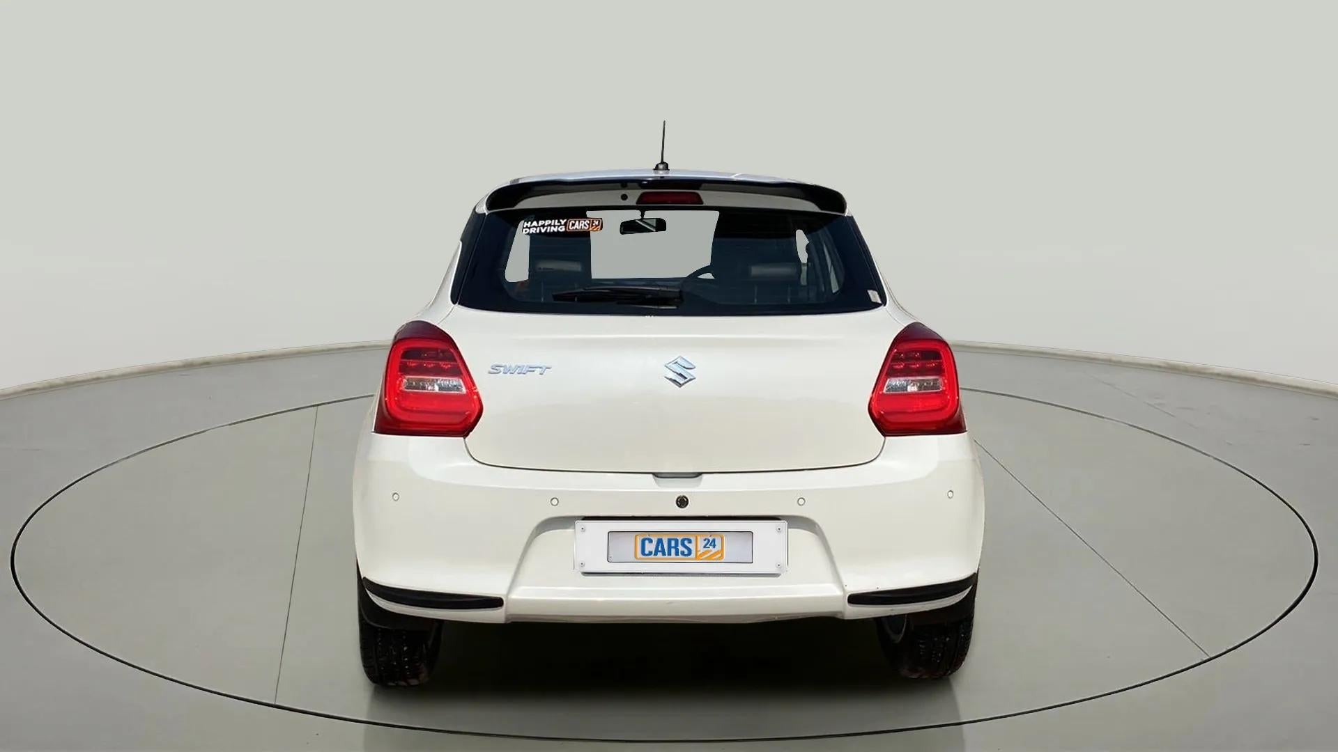 Rear view of a Pearl Arctic White with Pearl Midnight Black Maruti Suzuki Swift