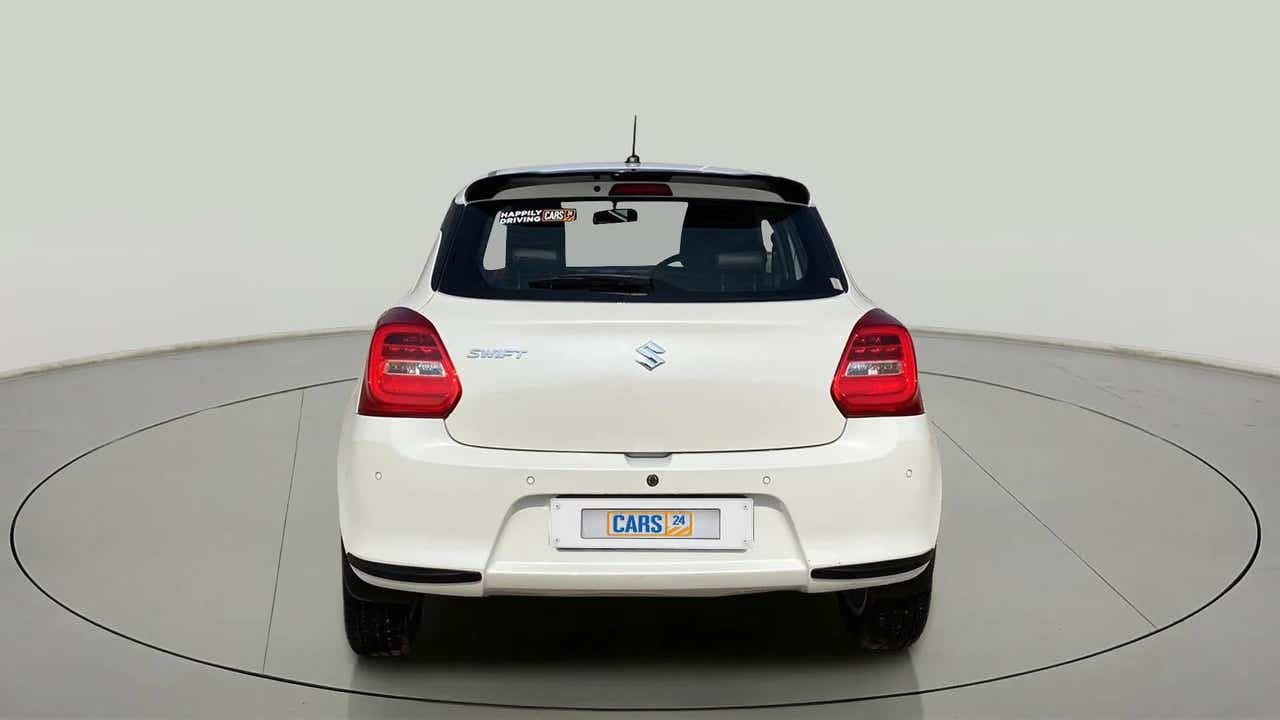 Rear view of a Pearl Arctic White with Pearl Midnight Black Maruti Suzuki Swift