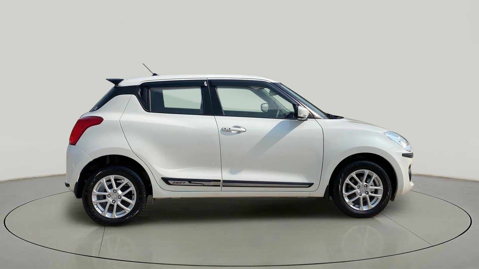 Side view of a Pearl Arctic White with Pearl Midnight Black Maruti Suzuki Swift