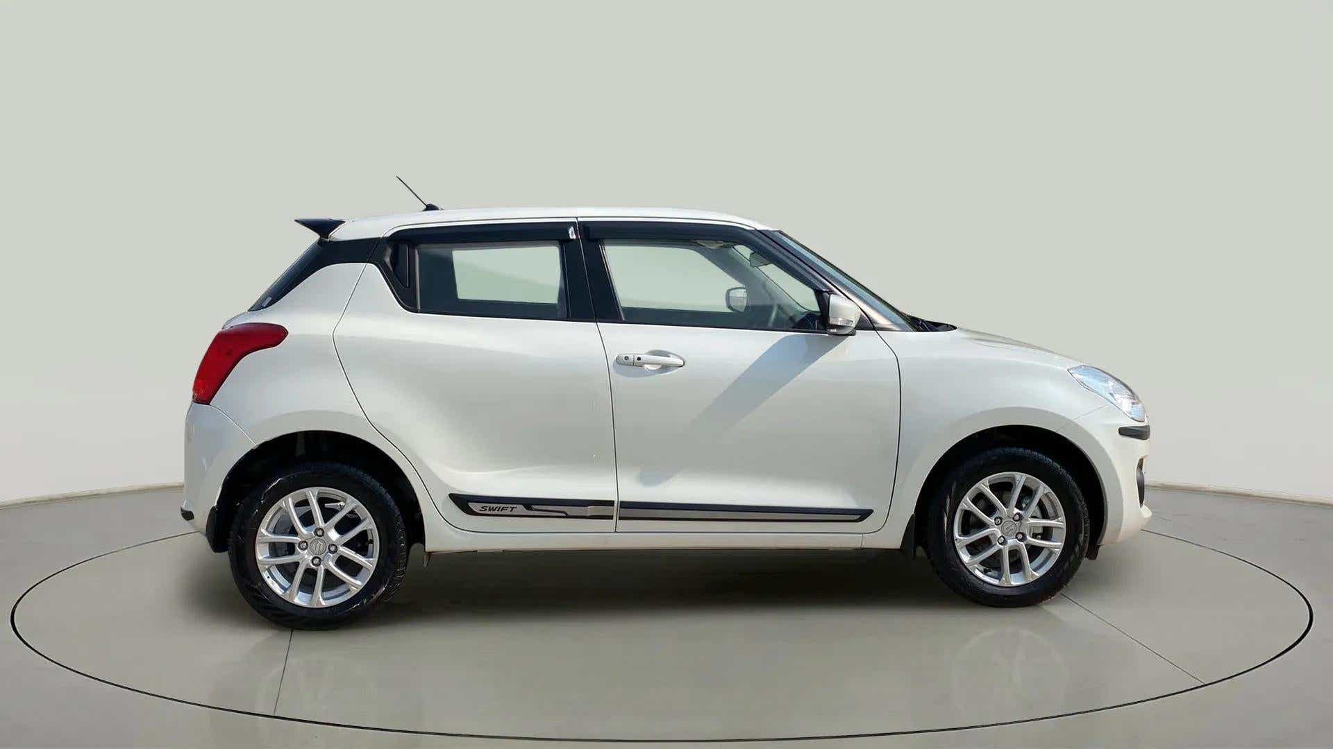 Side view of a Pearl Arctic White with Pearl Midnight Black Maruti Suzuki Swift