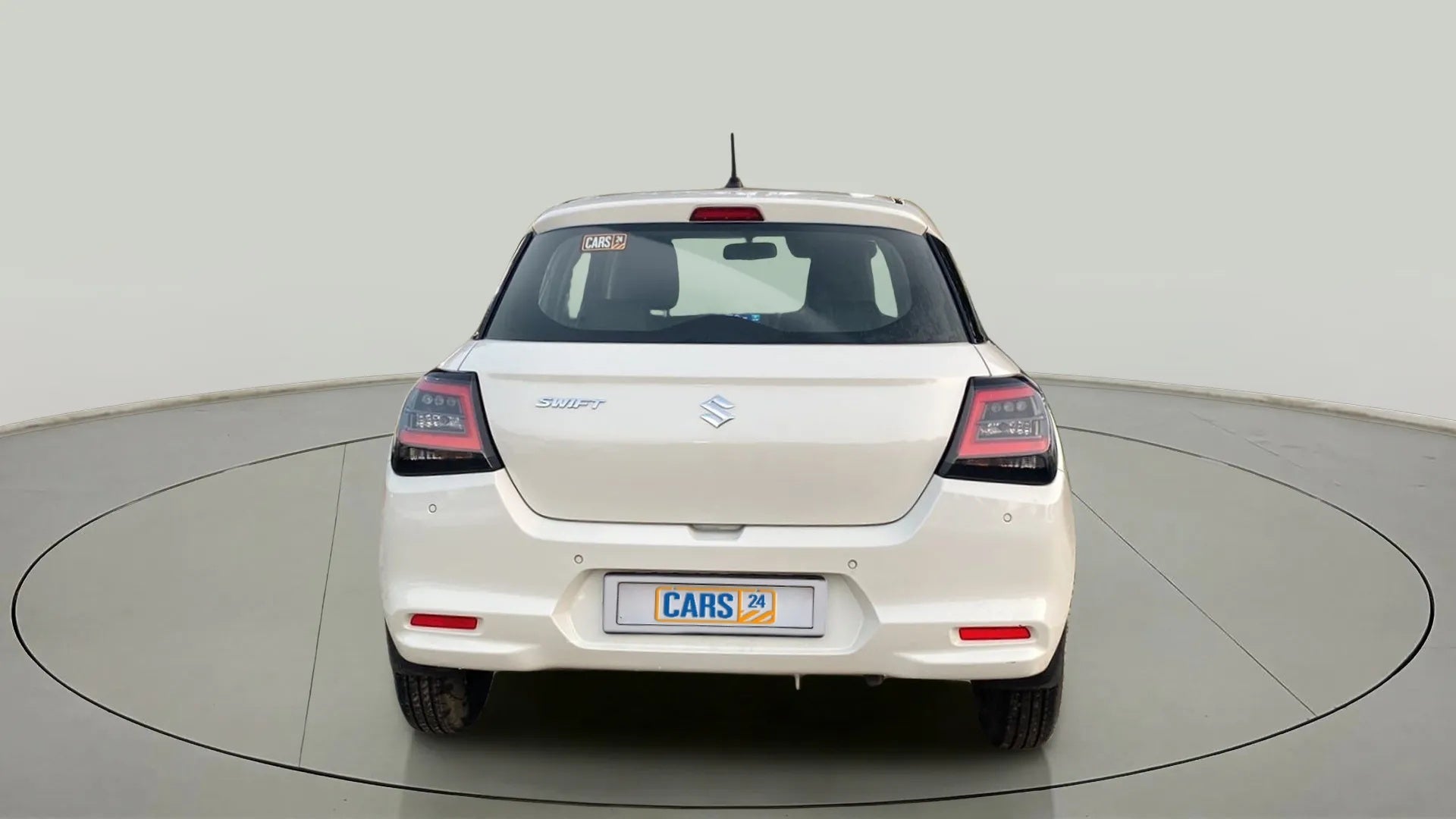 Rear view of a Pearl Arctic White with Pearl Midnight Black Maruti Suzuki Swift