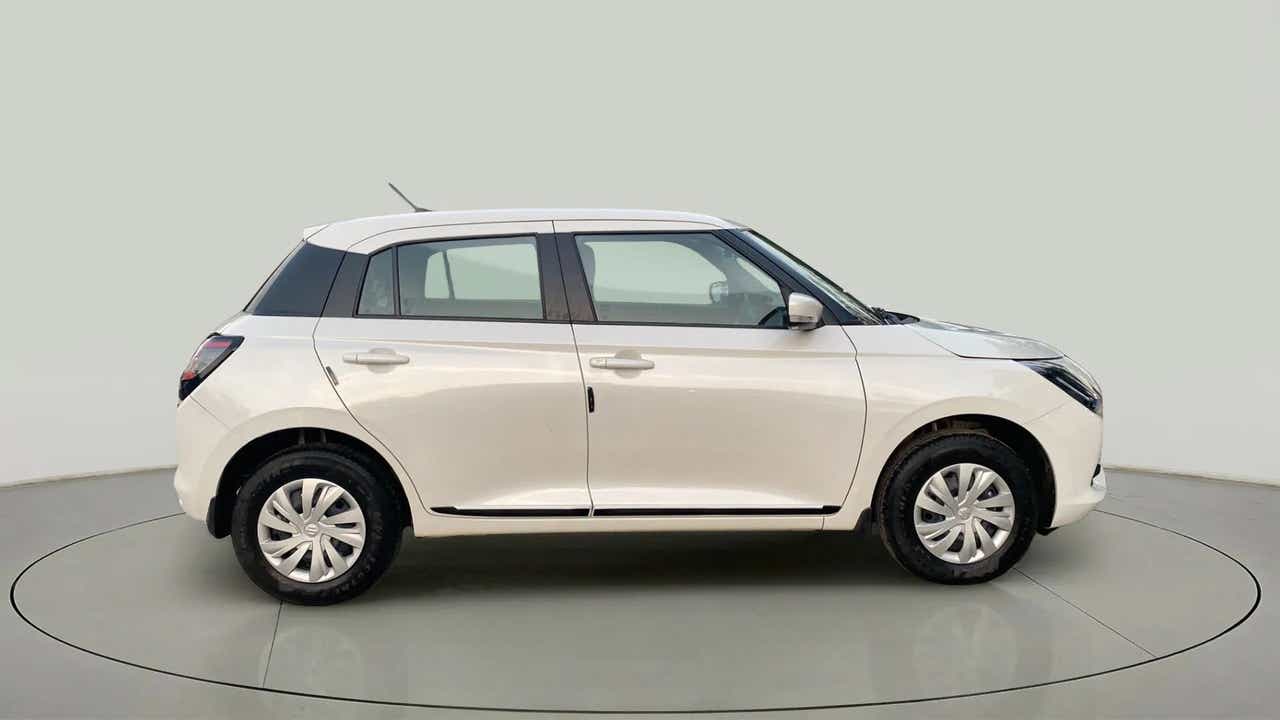Side view of a Pearl Arctic White with Pearl Midnight Black Maruti Suzuki Swift