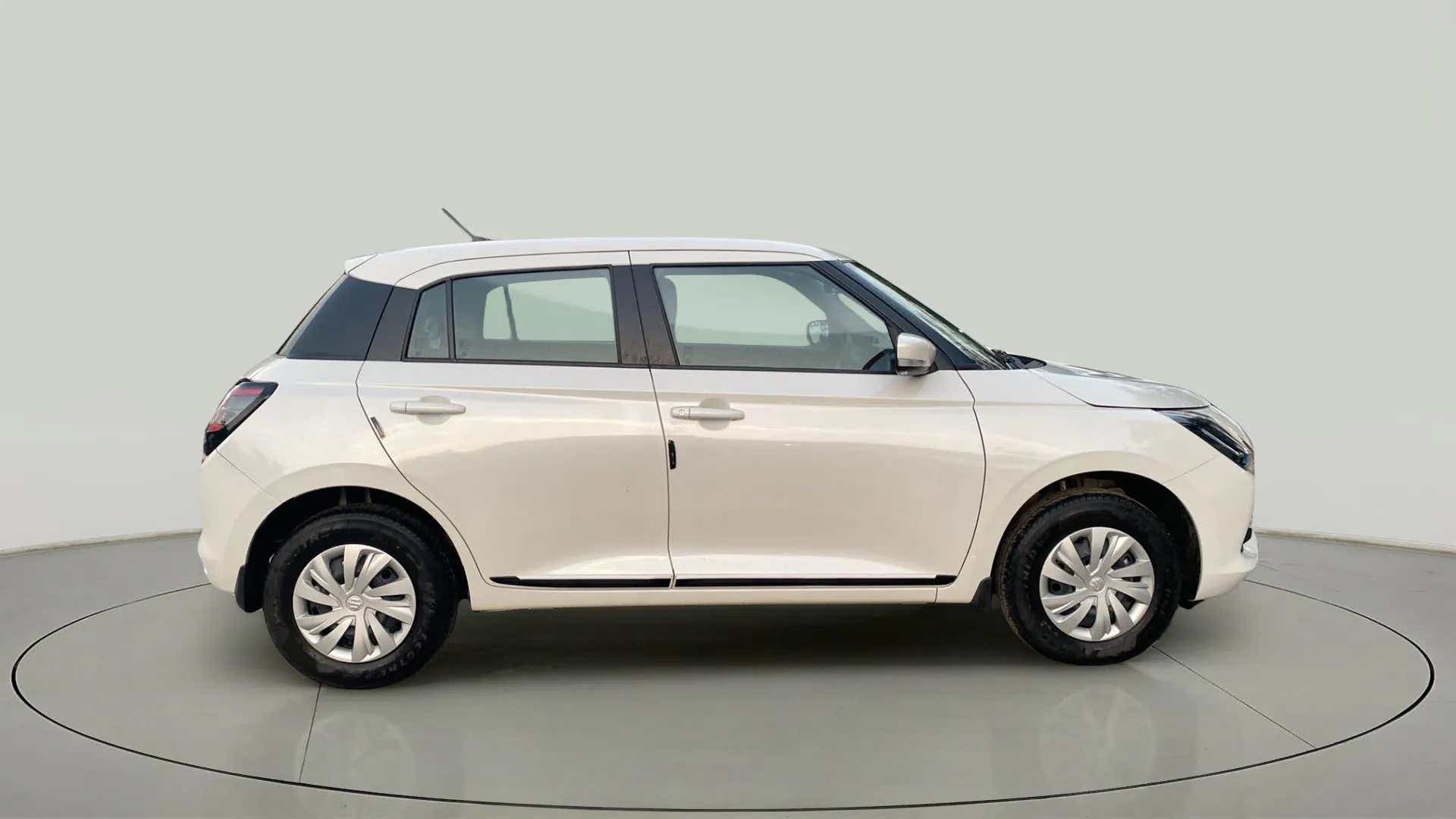 Side view of a Pearl Arctic White with Pearl Midnight Black Maruti Suzuki Swift